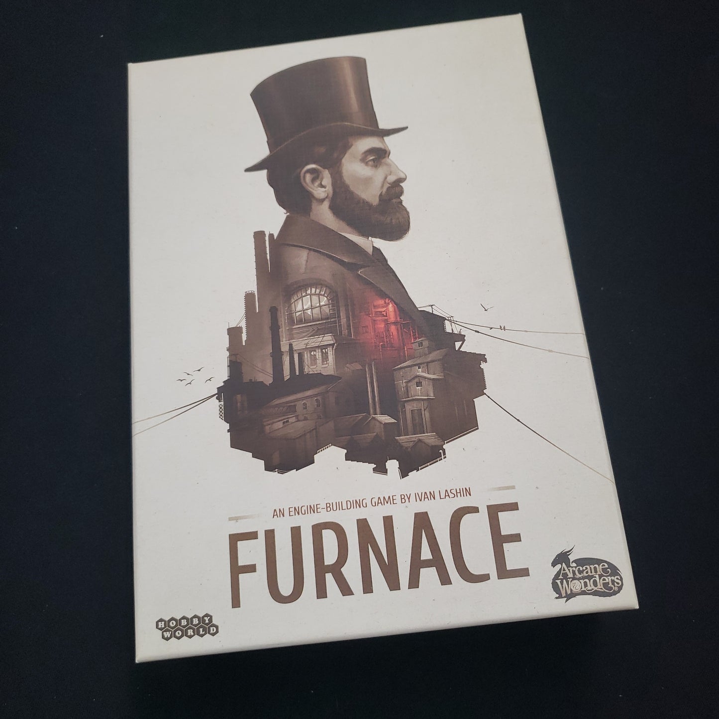 Image shows the front cover of the box of the Furnace board game