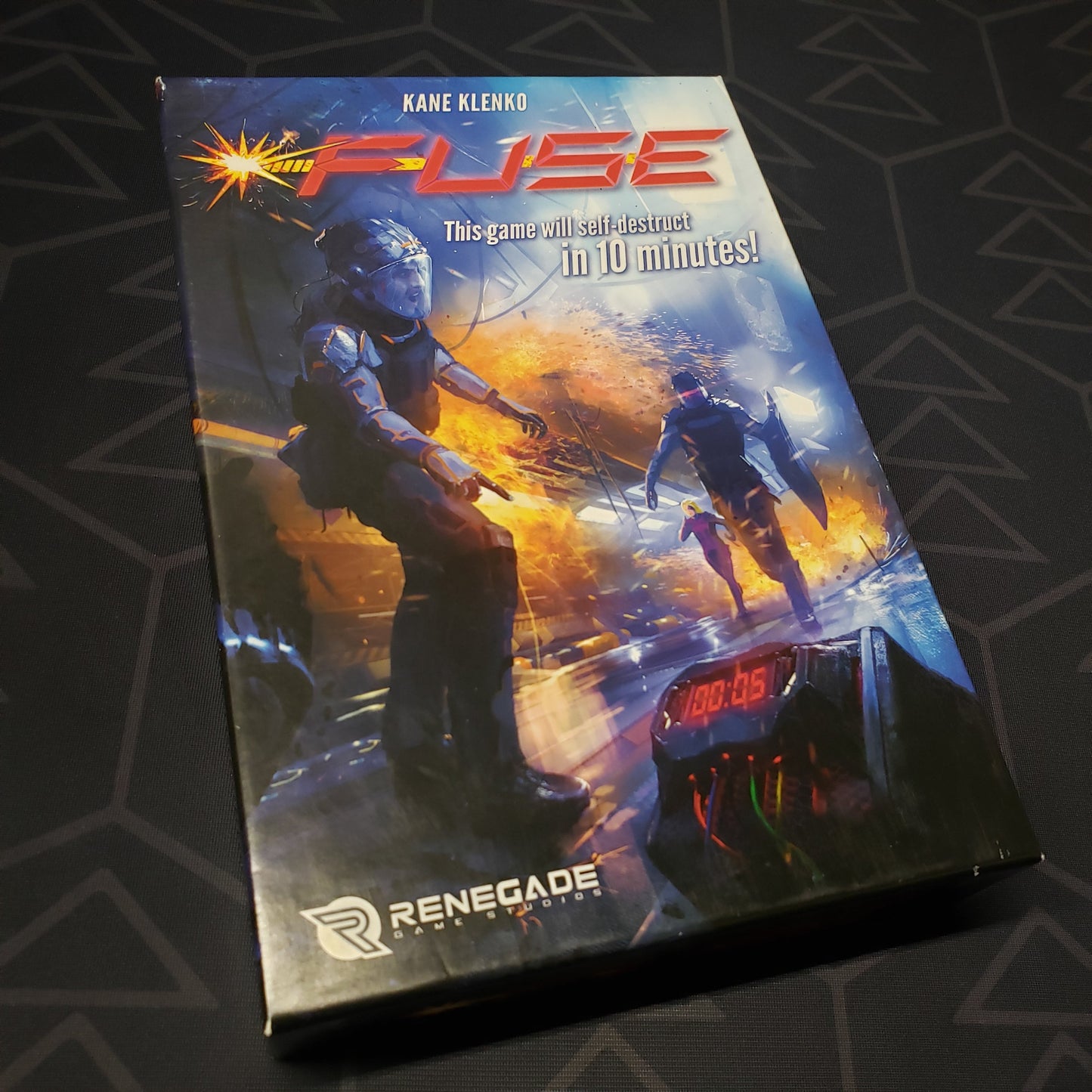 Image shows the front cover of the box of the FUSE board game