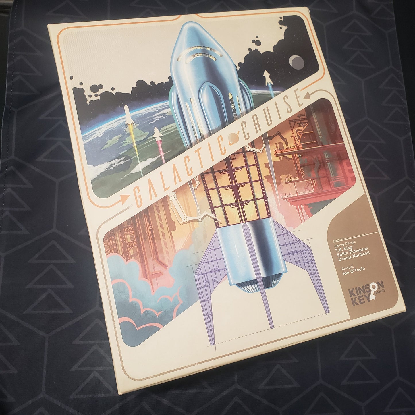 Image shows the front cover of the box for the Galactic Cruise board game