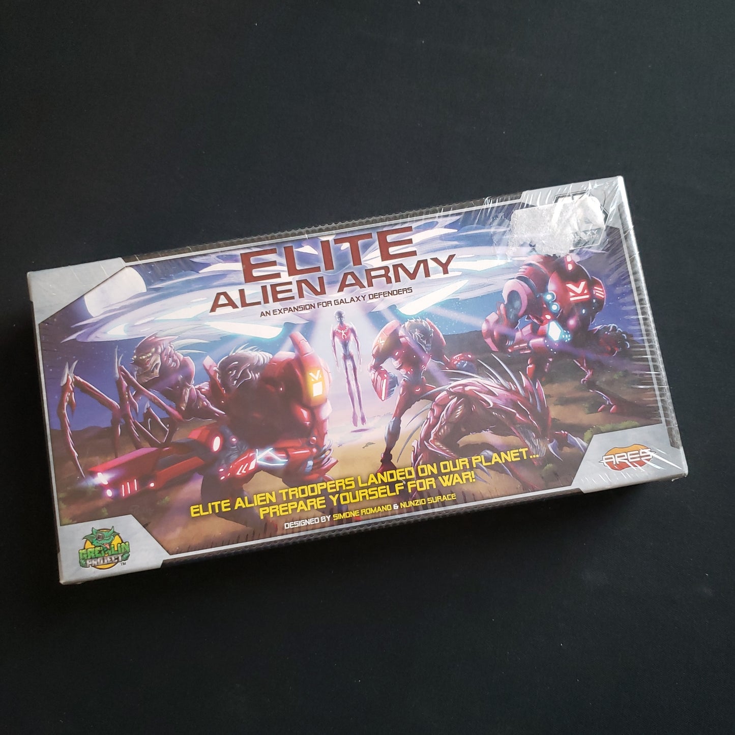 Image shows the front cover of the box of the Elite Alien Army expansion for the board game Galaxy Defenders