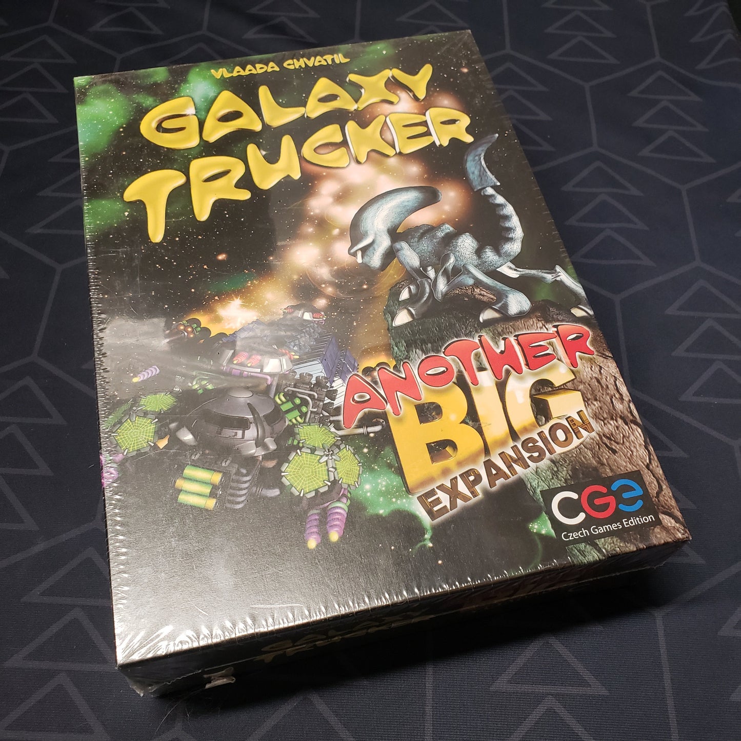 Image shows the front cover of the box of the Another Big expansion for the board game Galaxy Trucker