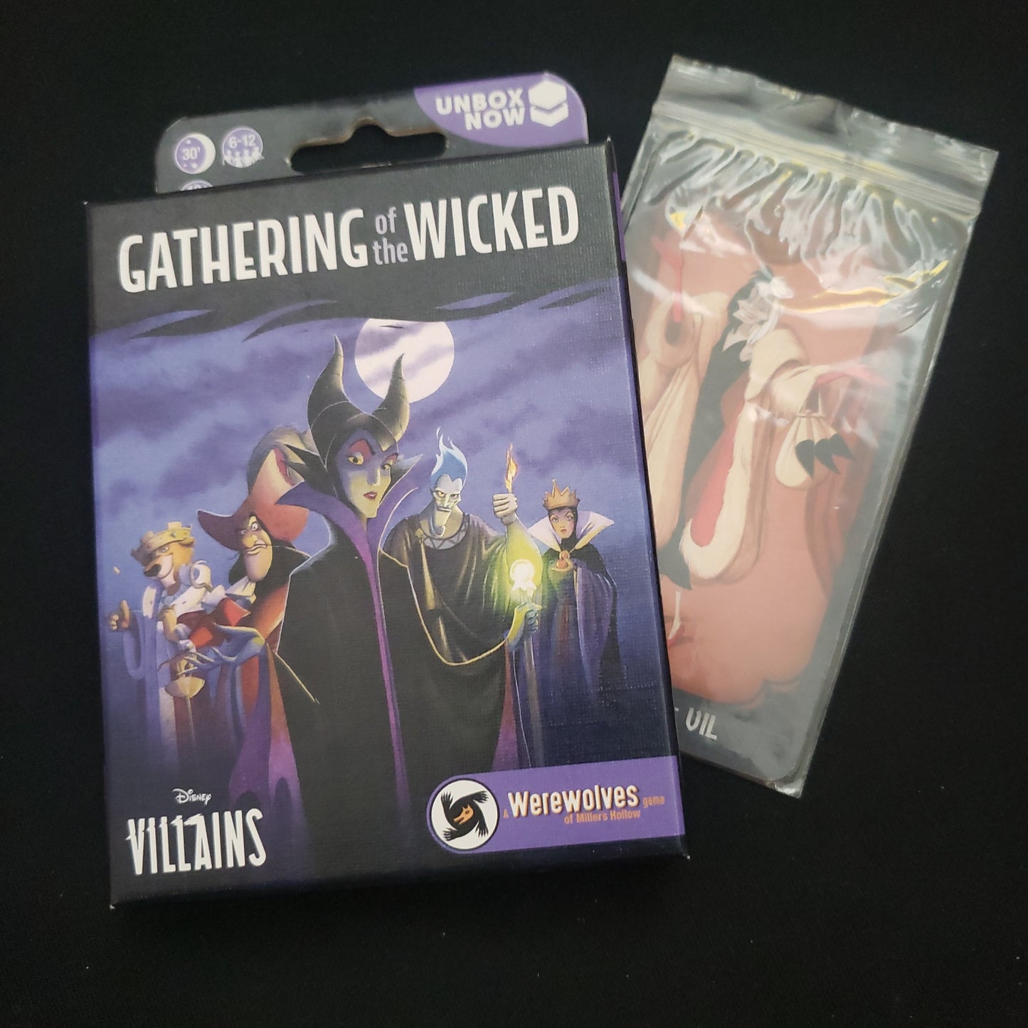 Image shows the front cover of the box of the Gathering of the Wicked card game, sitting on top of the Cruella de Vil pack