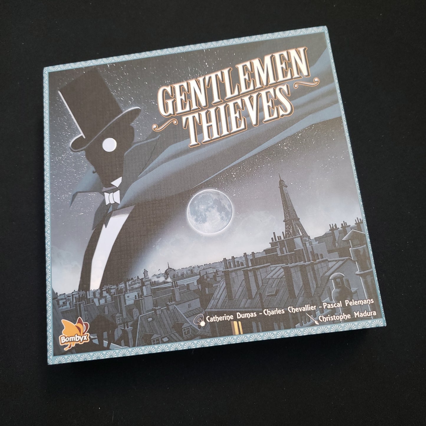 Image shows the front cover of the box of the Gentlemen Thieves board game