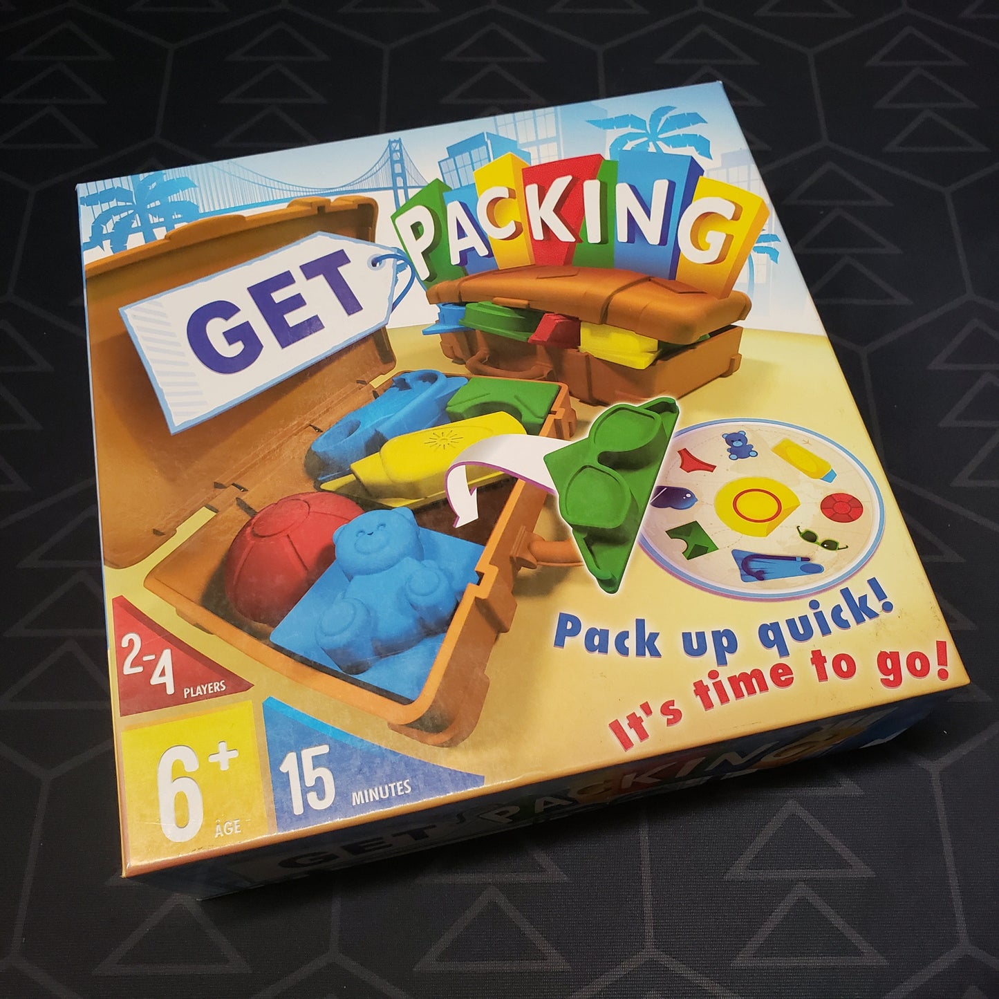 Image shows the front cover of the box of the Get Packing board game