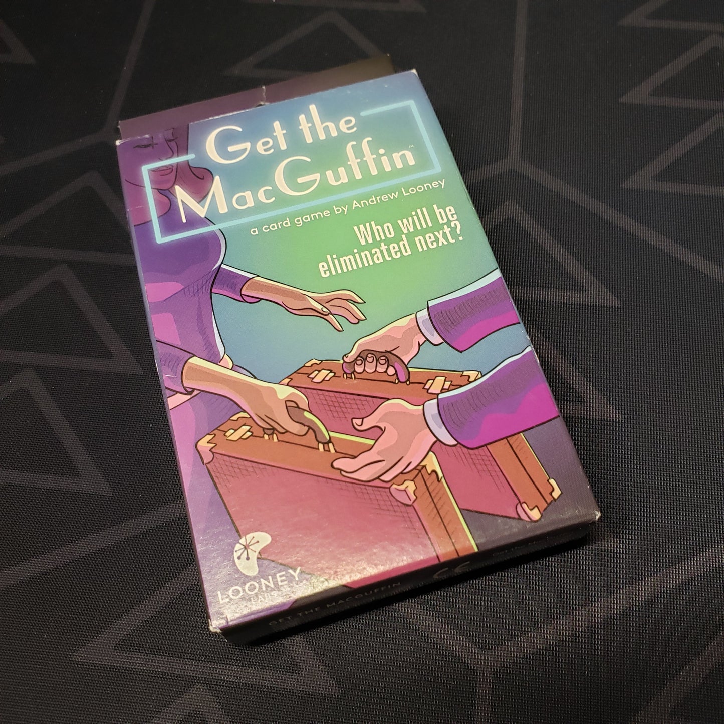 Image shows the front cover of the box for the Get the MacGuffin card game