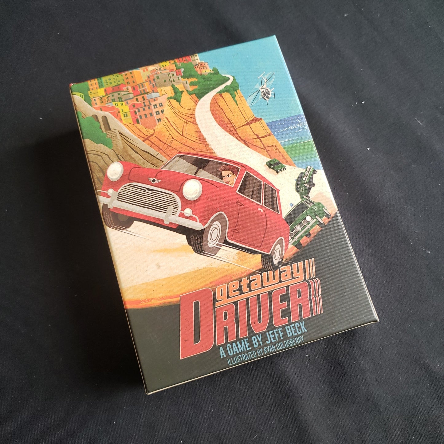 Image shows the front cover of the box of the Getaway Driver board game