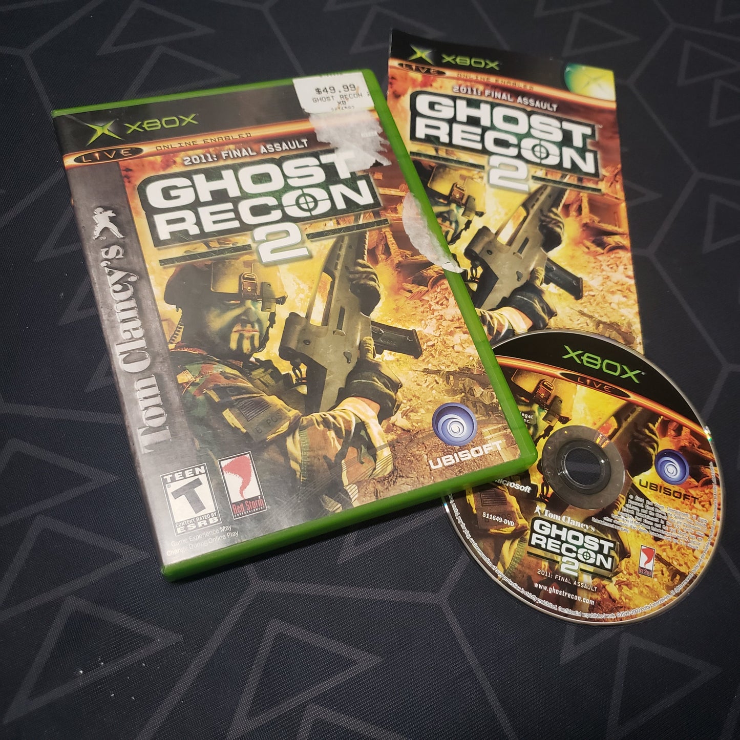 Image shows the case, manual and disc for the video game Ghost Recon 2 for the original Xbox