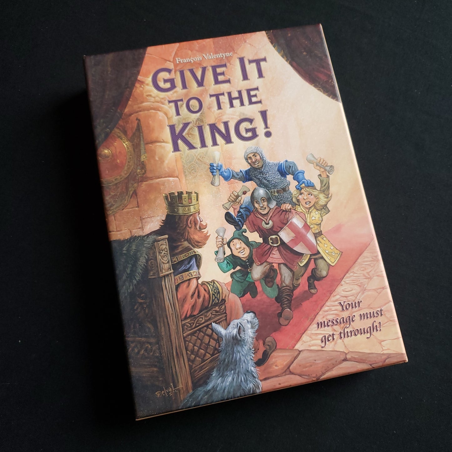 Image shows the front cover of the box of the Give It To The King! board game
