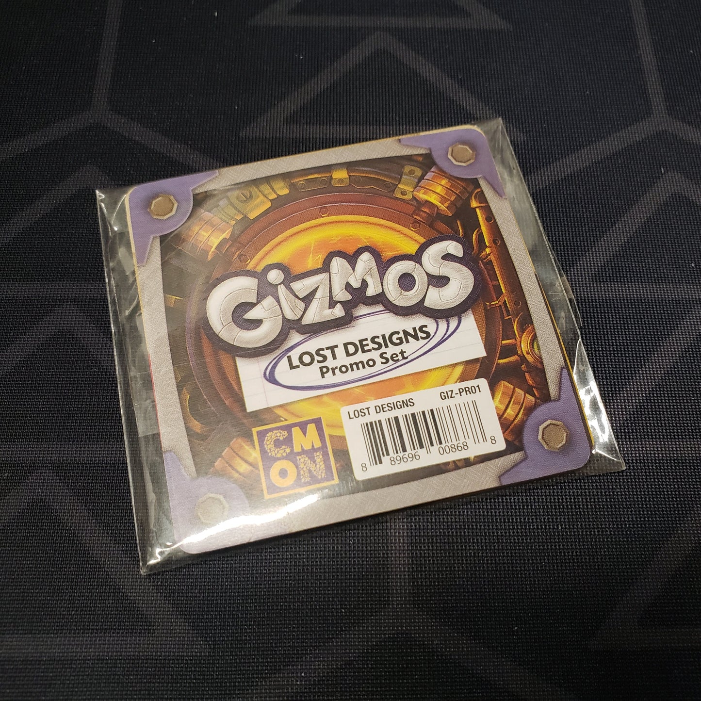 Image shows the front of the package for the Lost Designs Promo Set for the board game Gizmos