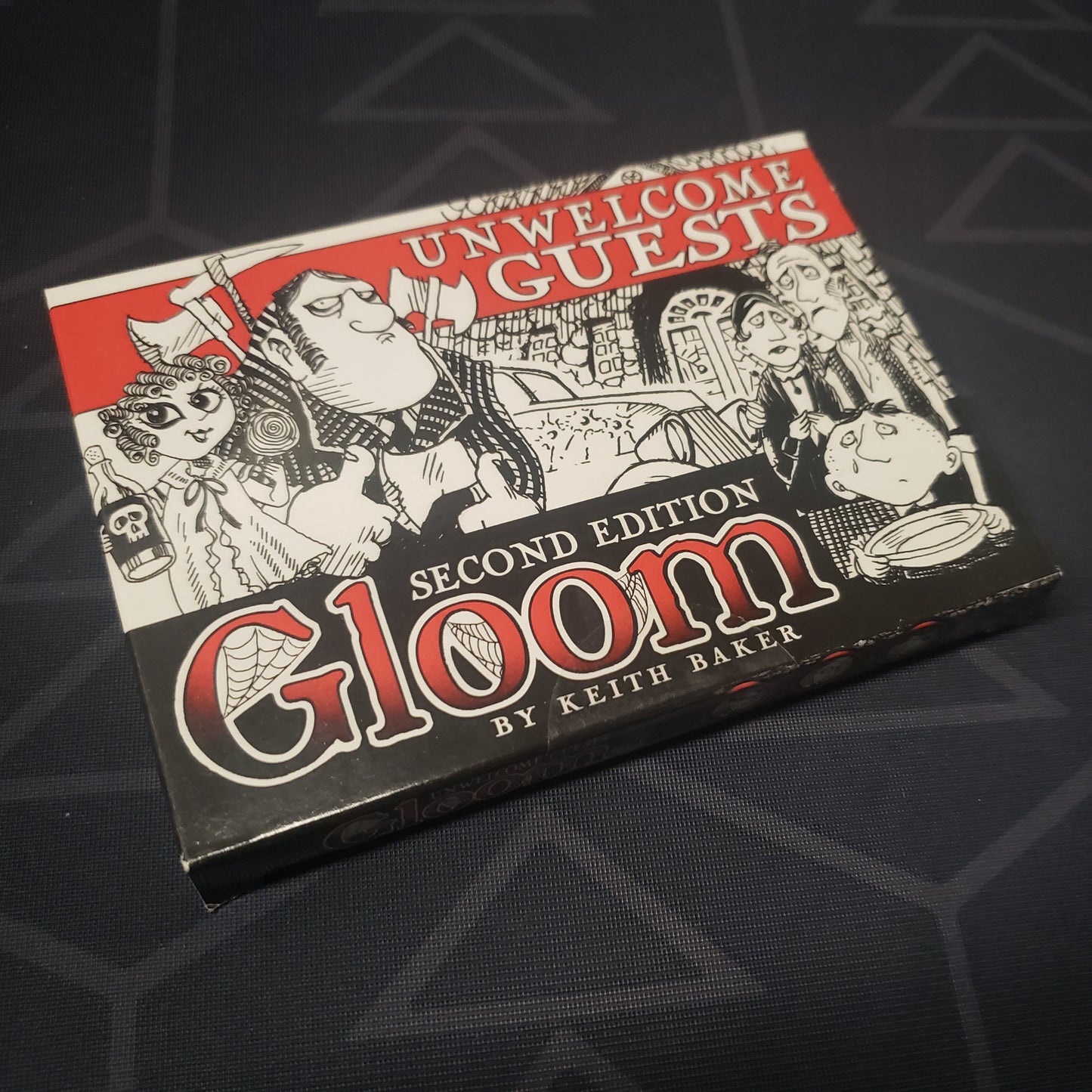 Image shows the front cover of the box of the Unwelcome Guests expansion for the card game Gloom (Second Edition)