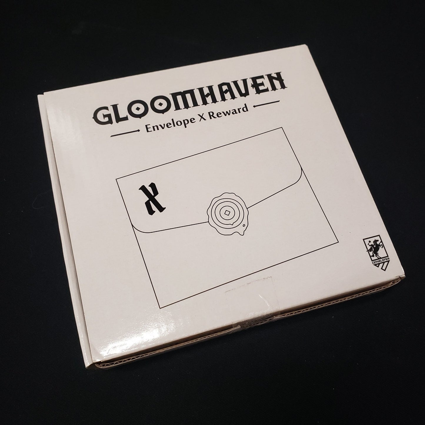 Image shows the components for the Envelope X Reward expansion from the board game Gloomhaven