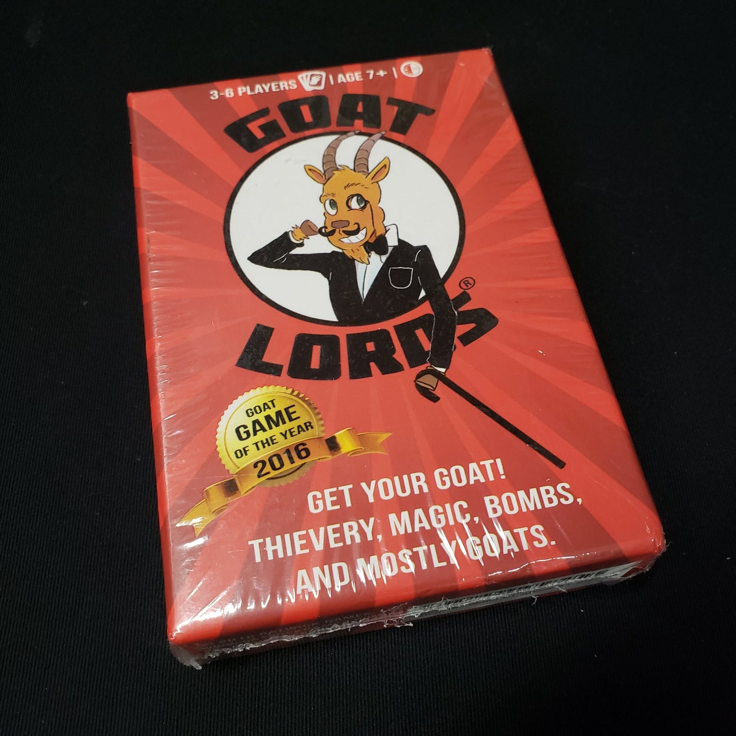 Image shows the front cover of the box of the Goat Lords card game