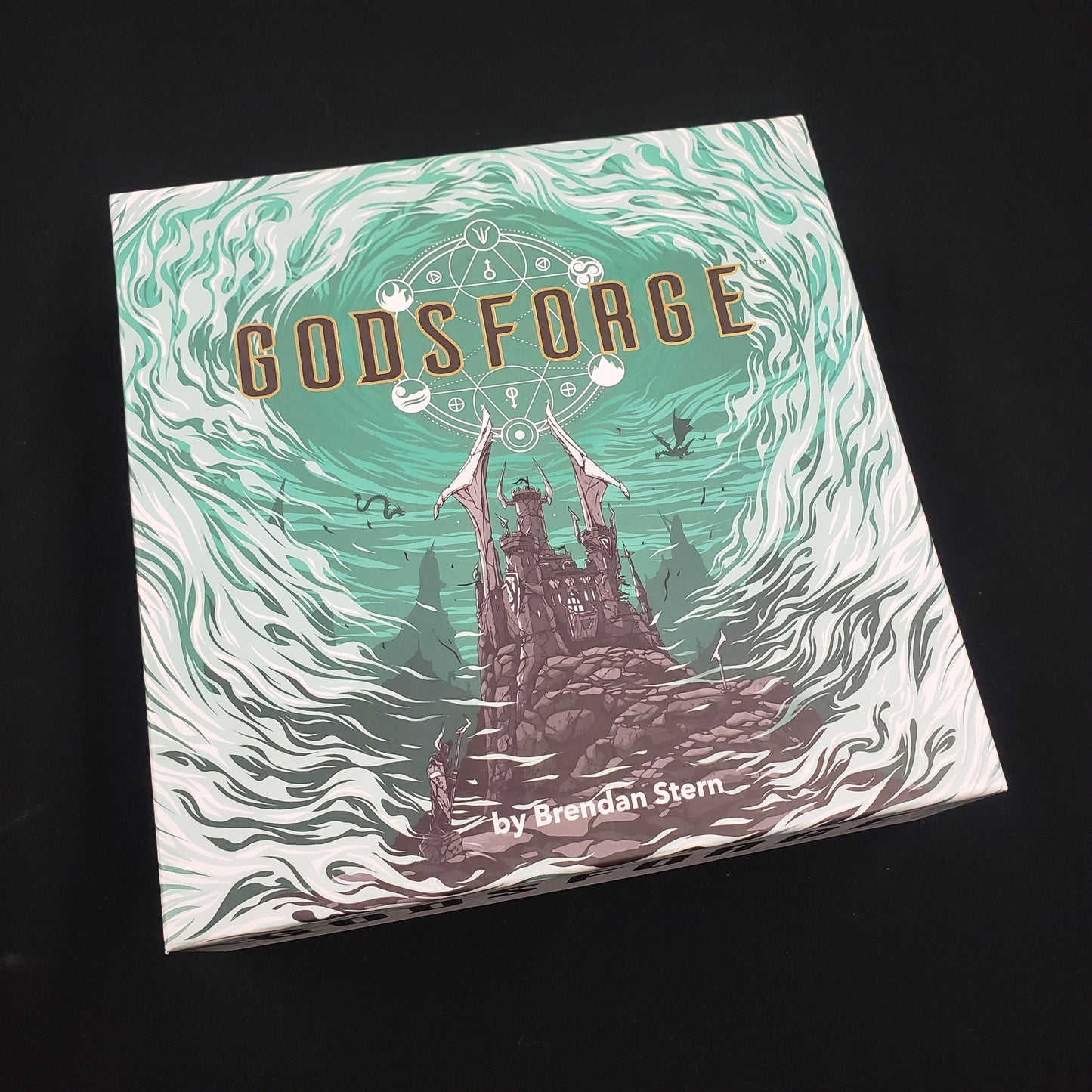 Image shows the front cover of the box of the Godsforge board game