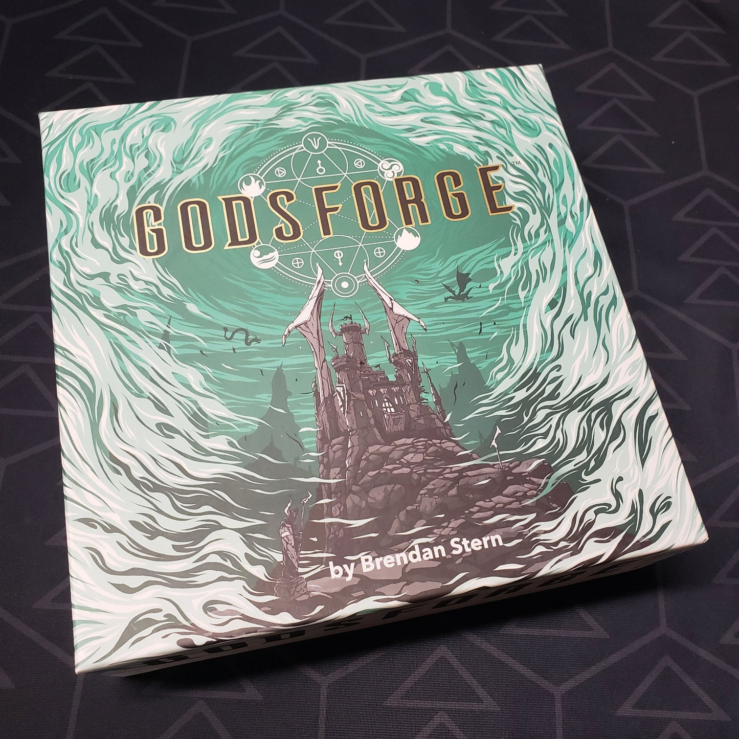 Image shows the front cover of the box of the Godsforge board game