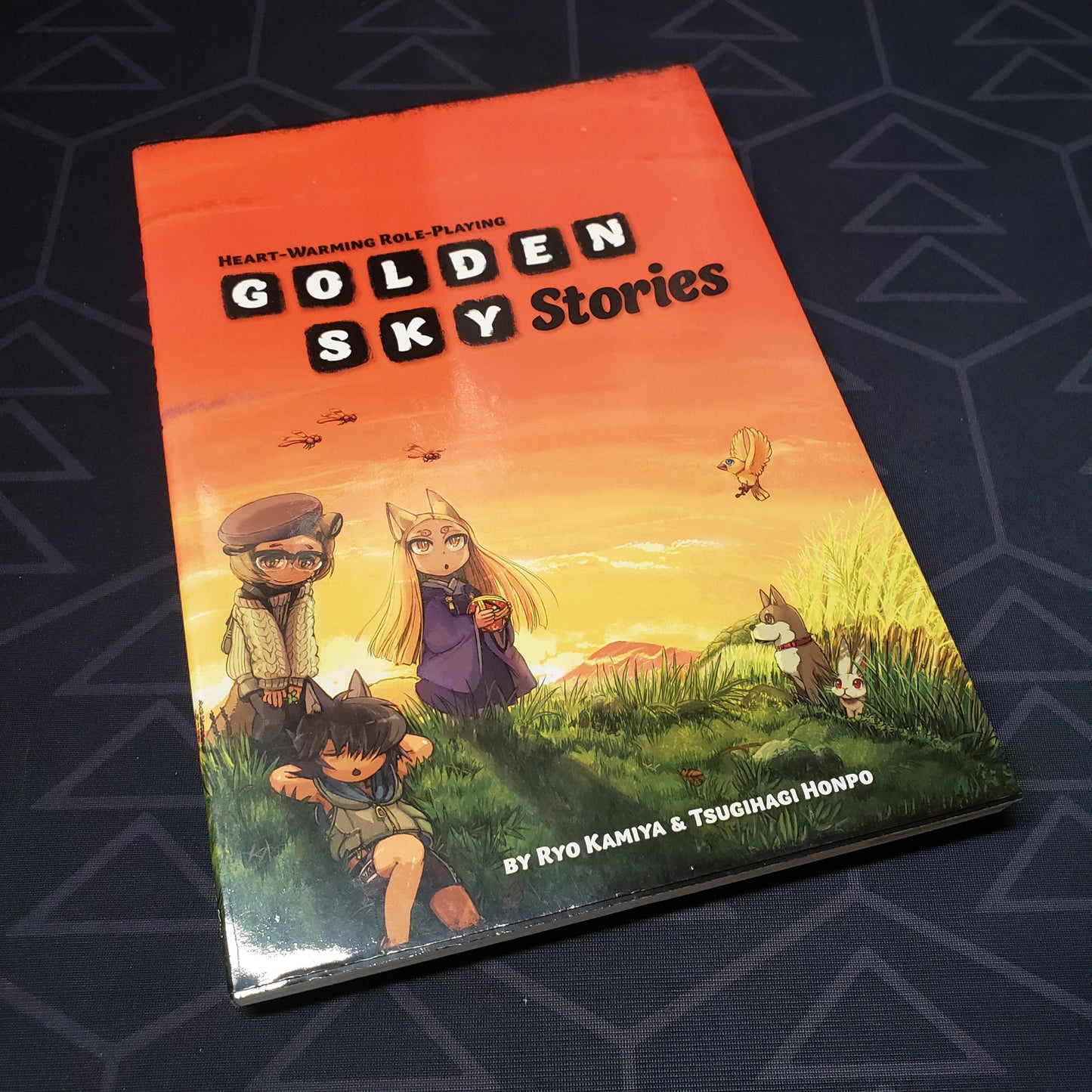 Image shows the front cover of the core rulebook for the roleplaying game Golden Sky Stories