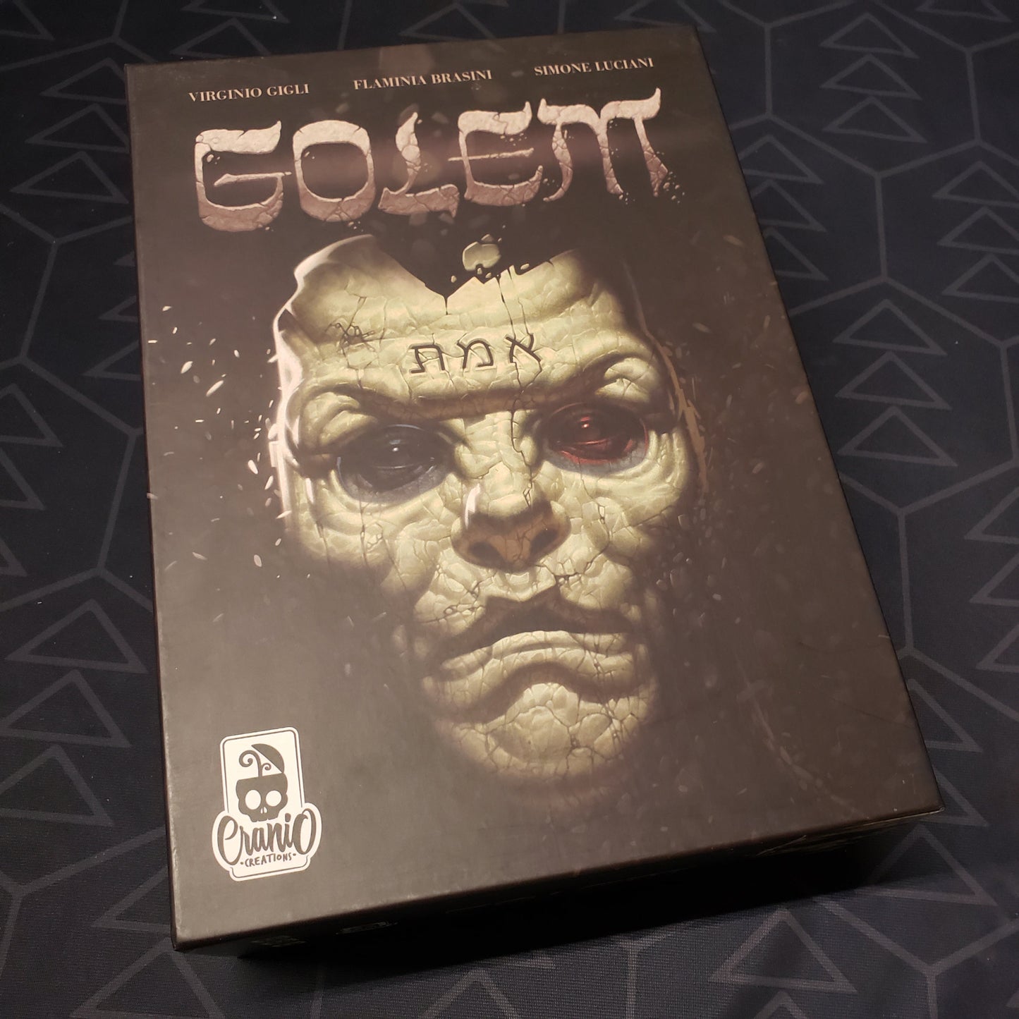 Image shows the front cover of the box of the Golem board game