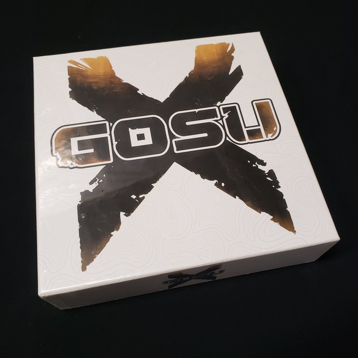 Image shows the front cover of the box of the Gosu X board game