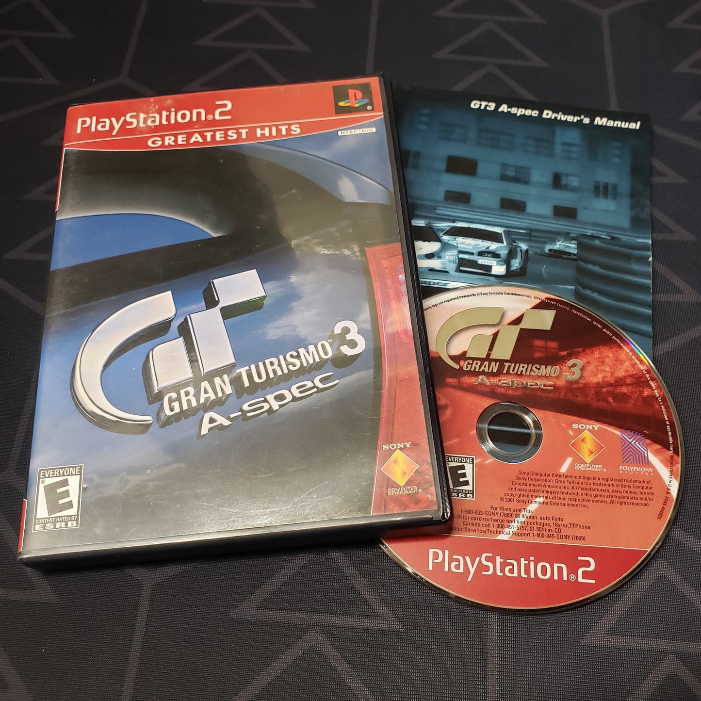 Image shows the case, manual & disc for the video game Gran Turismo 3: A-Spec for Playstation 2