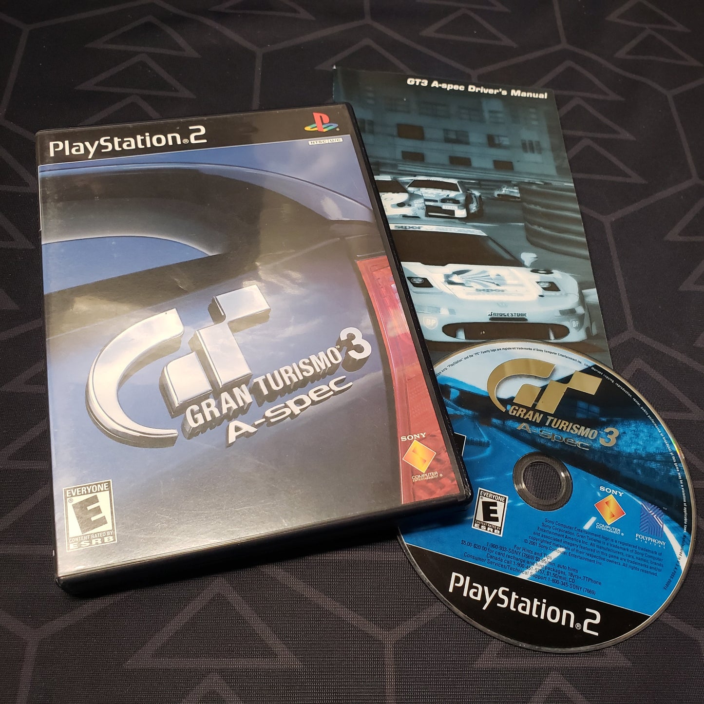 Image shows the case, manual & disc for the video game Gran Turismo 3: A-Spec for Playstation 2