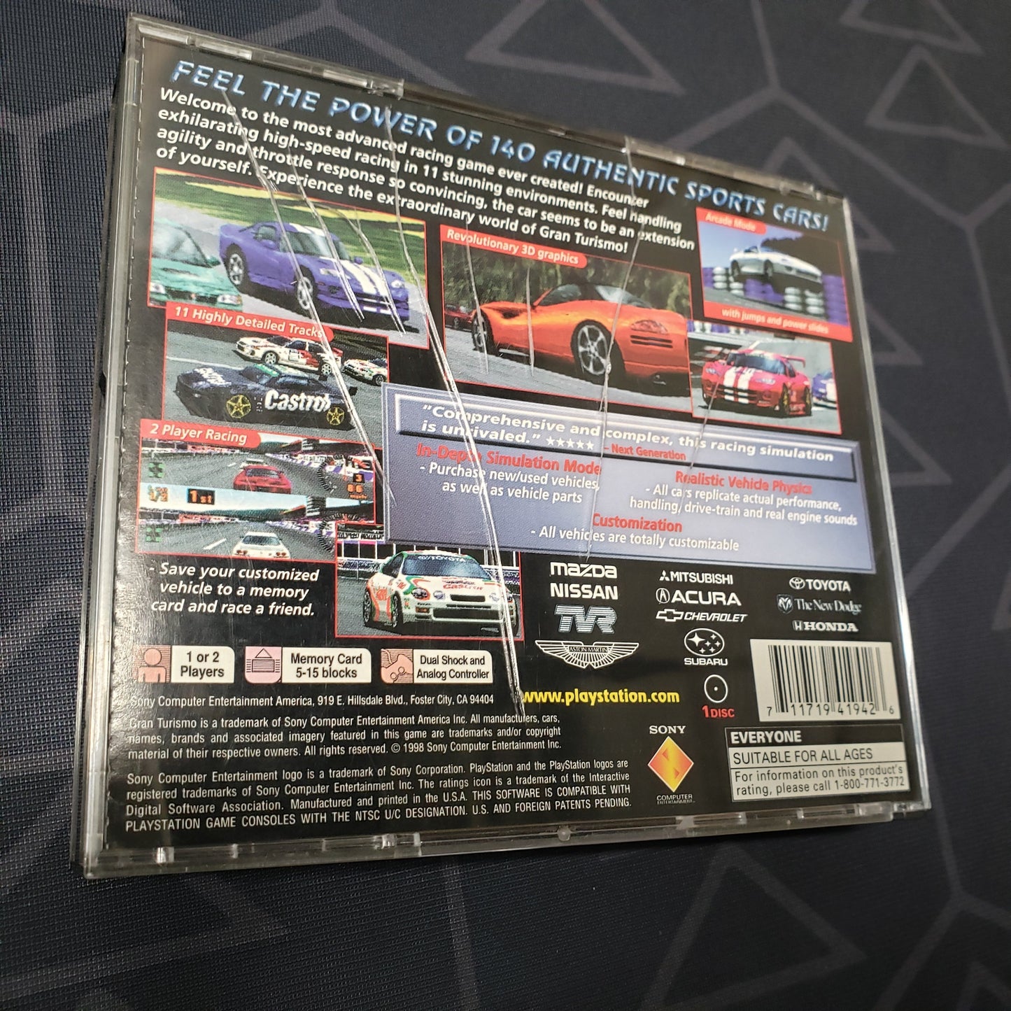 Image shows some cracks on the back of the jewel case for the video game Gran Turismo for Playstation 1