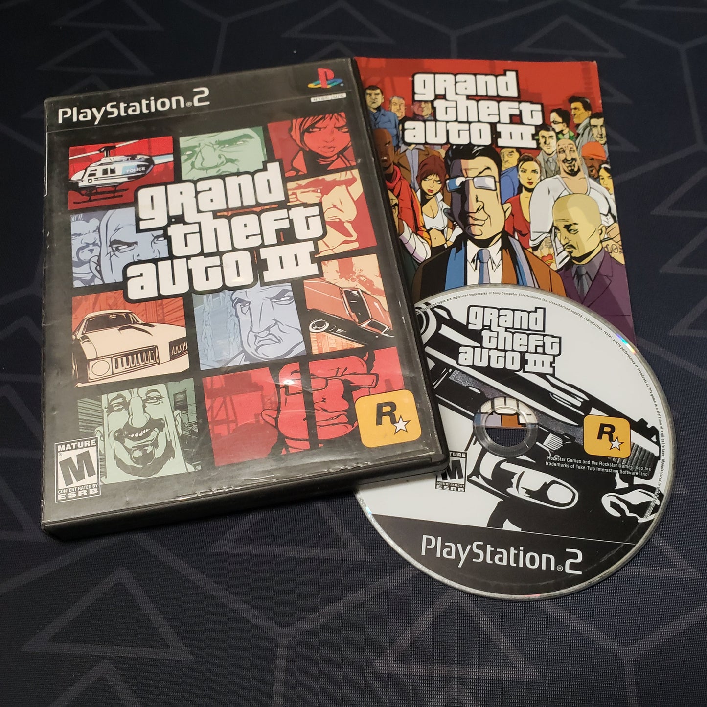 Image shows the case, manual & disc for the video game Grand Theft Auto III for Playstation 2