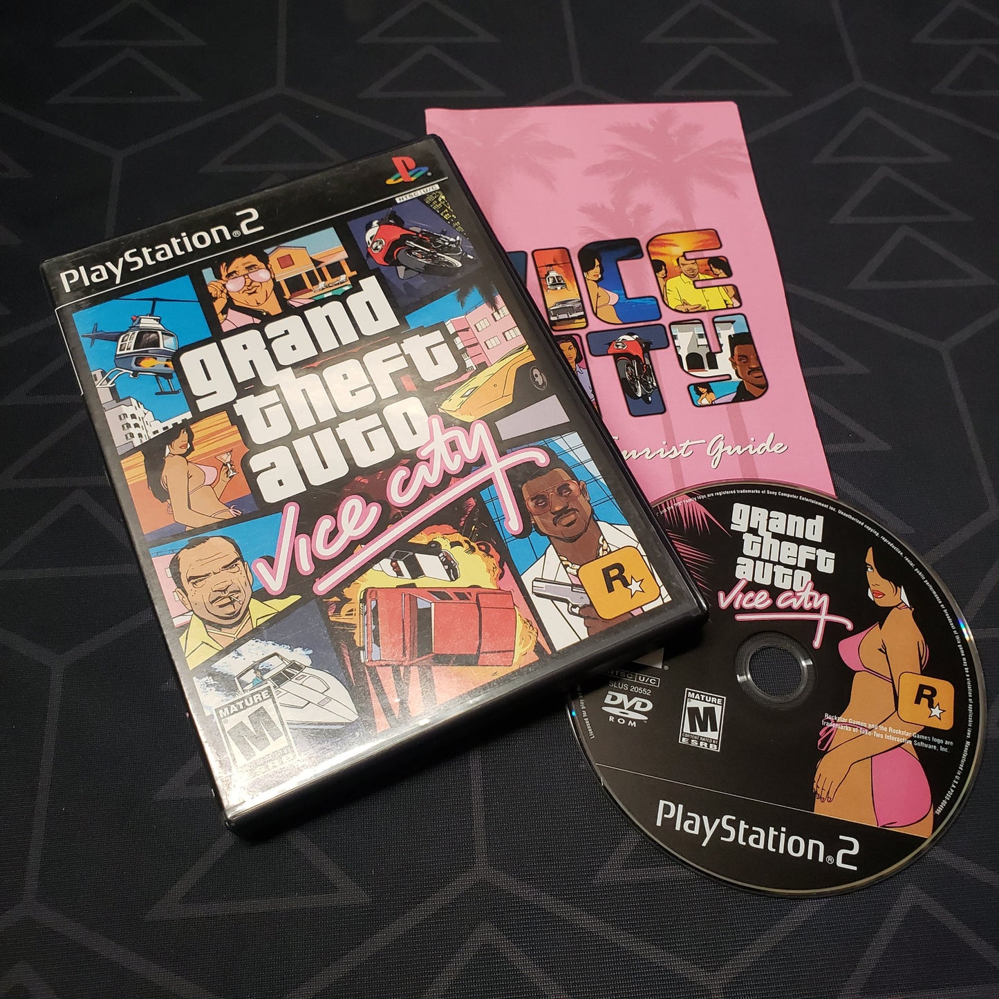 Image shows the case, manual and disc for the video game Grand Theft Auto: Vice City for Playstation 2