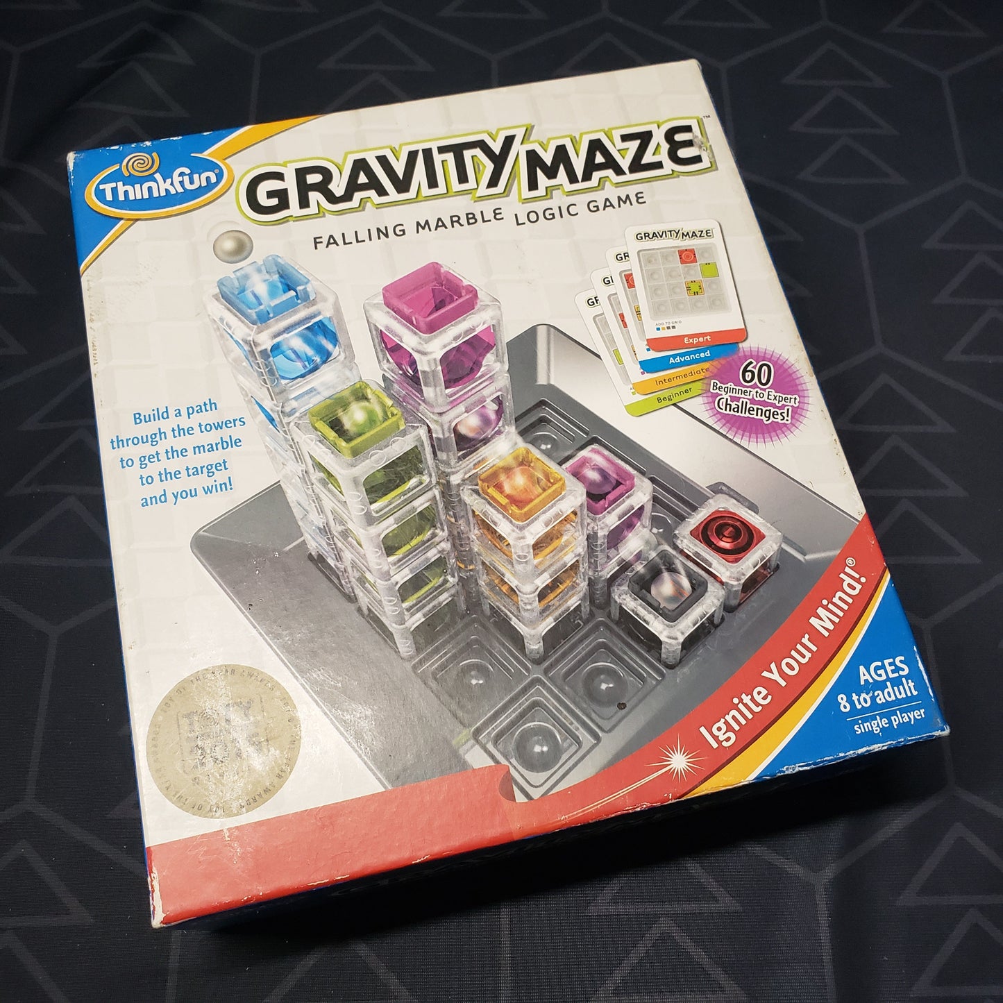 Image shows the front cover of the box for the Gravity Maze STEM board game
