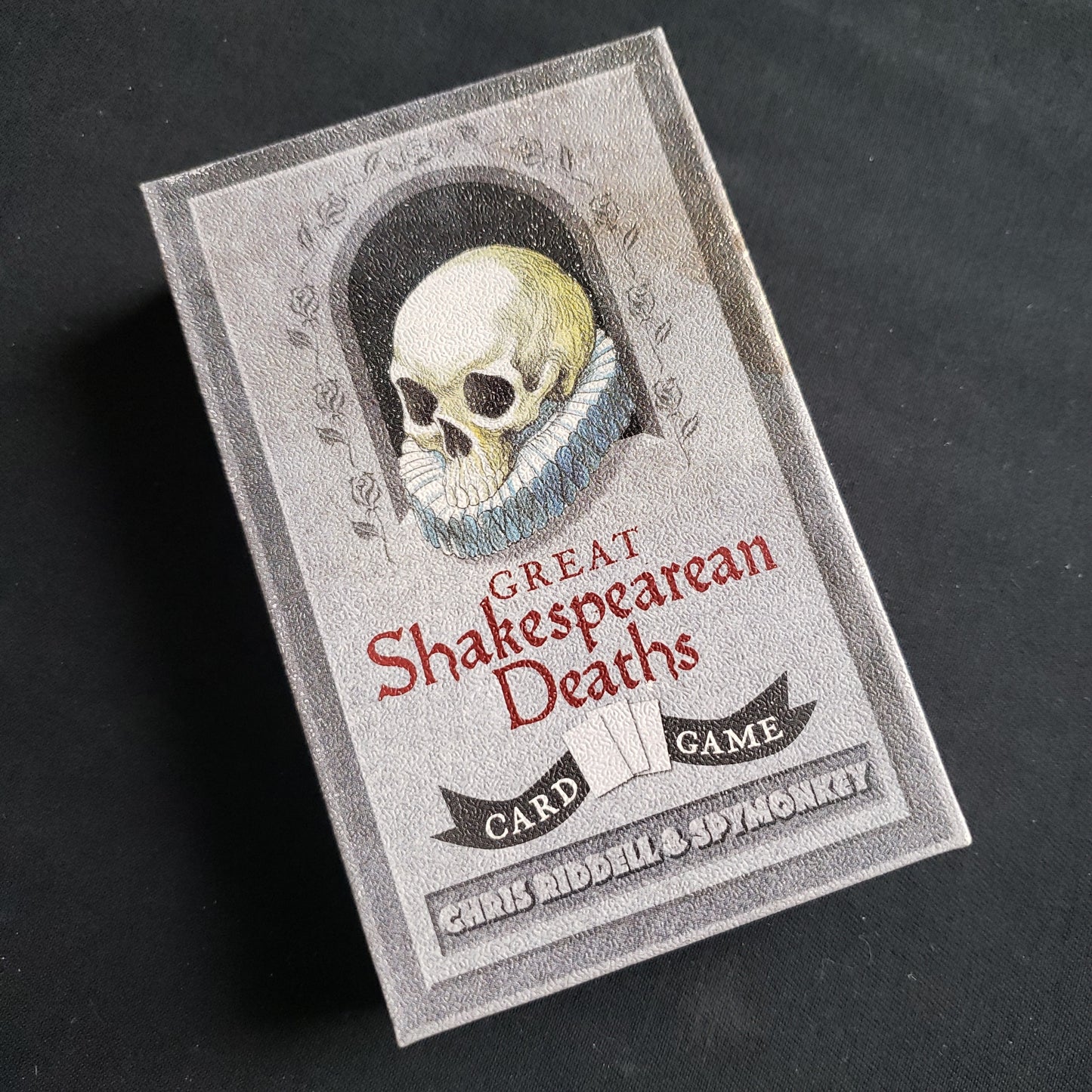 Image shows the front cover of the box of the Great Shakespearean Deaths card game