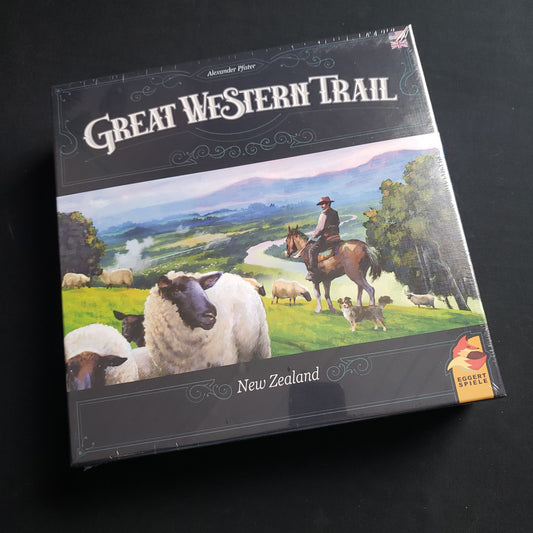 Image shows the front cover of the box of the Great Western Trail: New Zealand board game