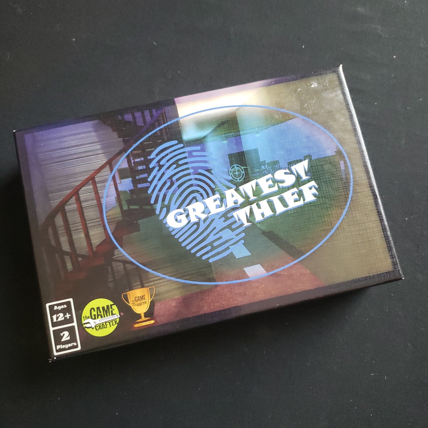 Image shows the front cover of the box of the Greatest Thief board game