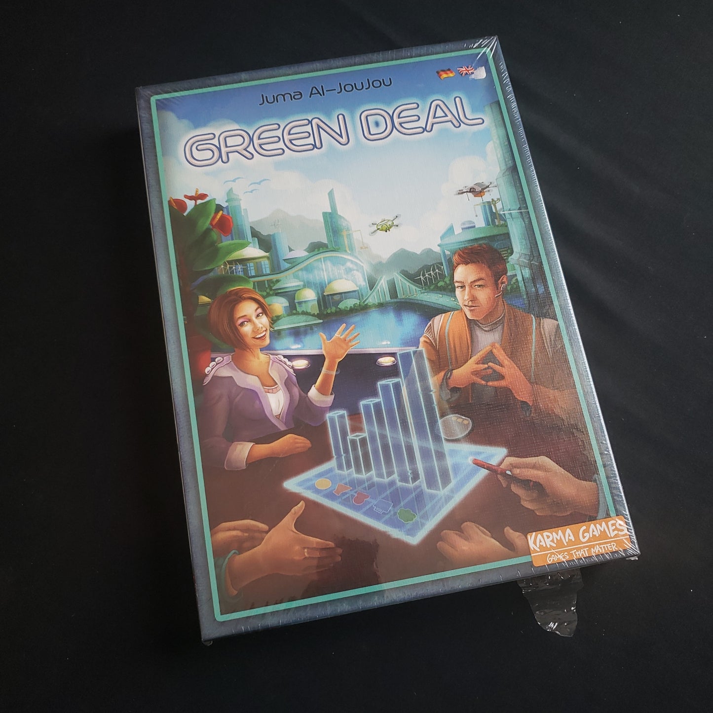 Image shows the front cover of the box of the Green Deal board game