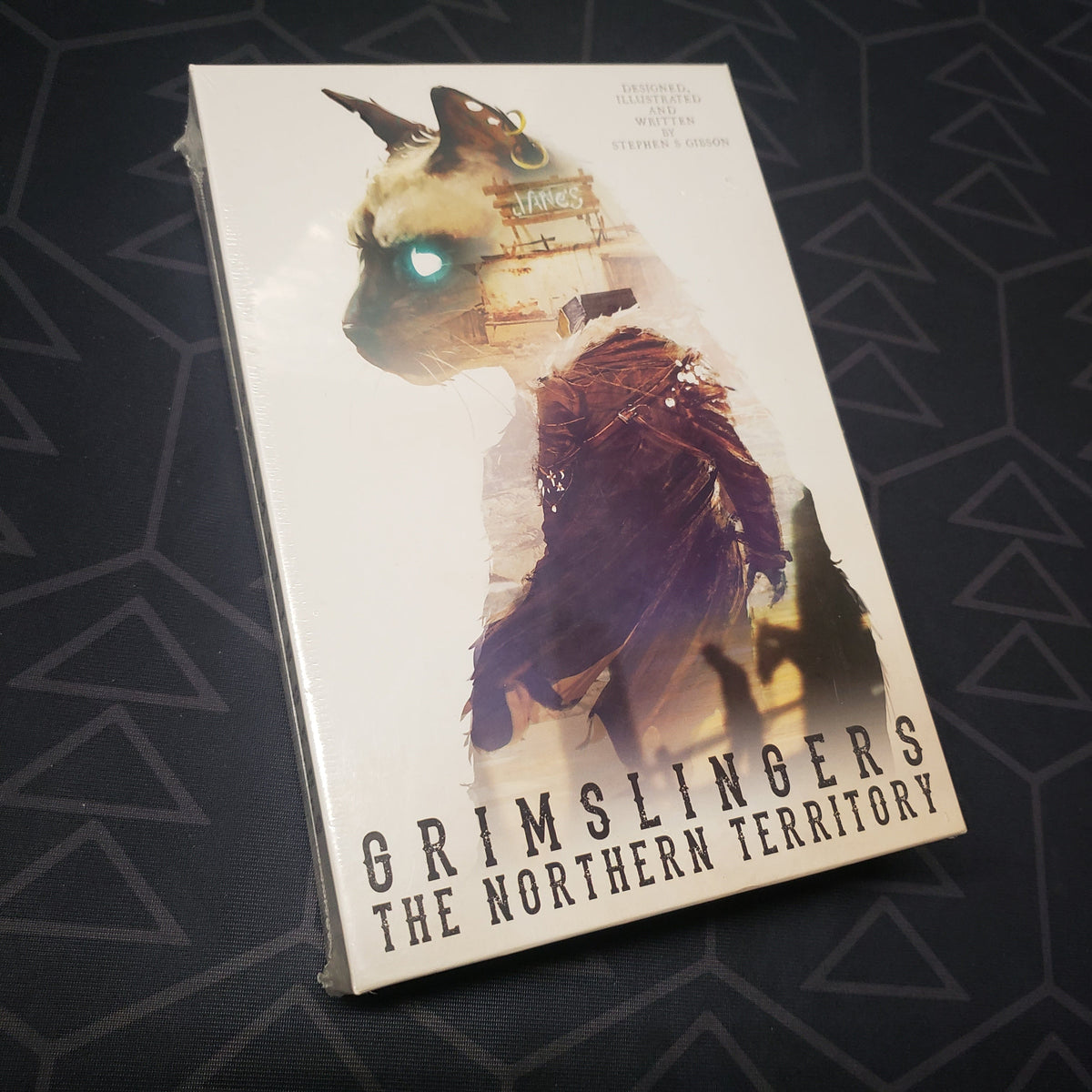 Image shows the front cover of the box of the Northern Territory expansion for the card game Grimslingers