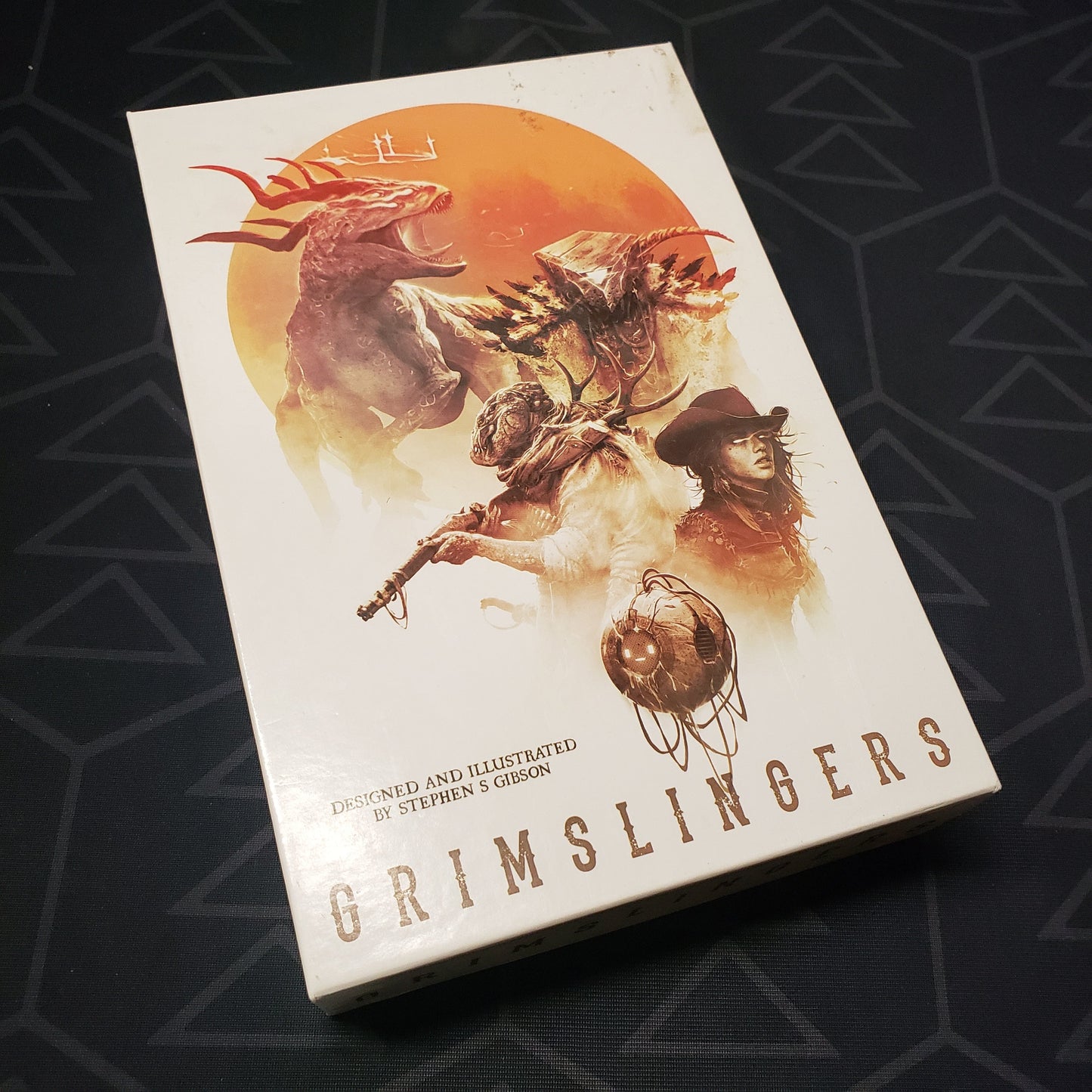 Image shows the front cover of the box for the Grimslingers card game