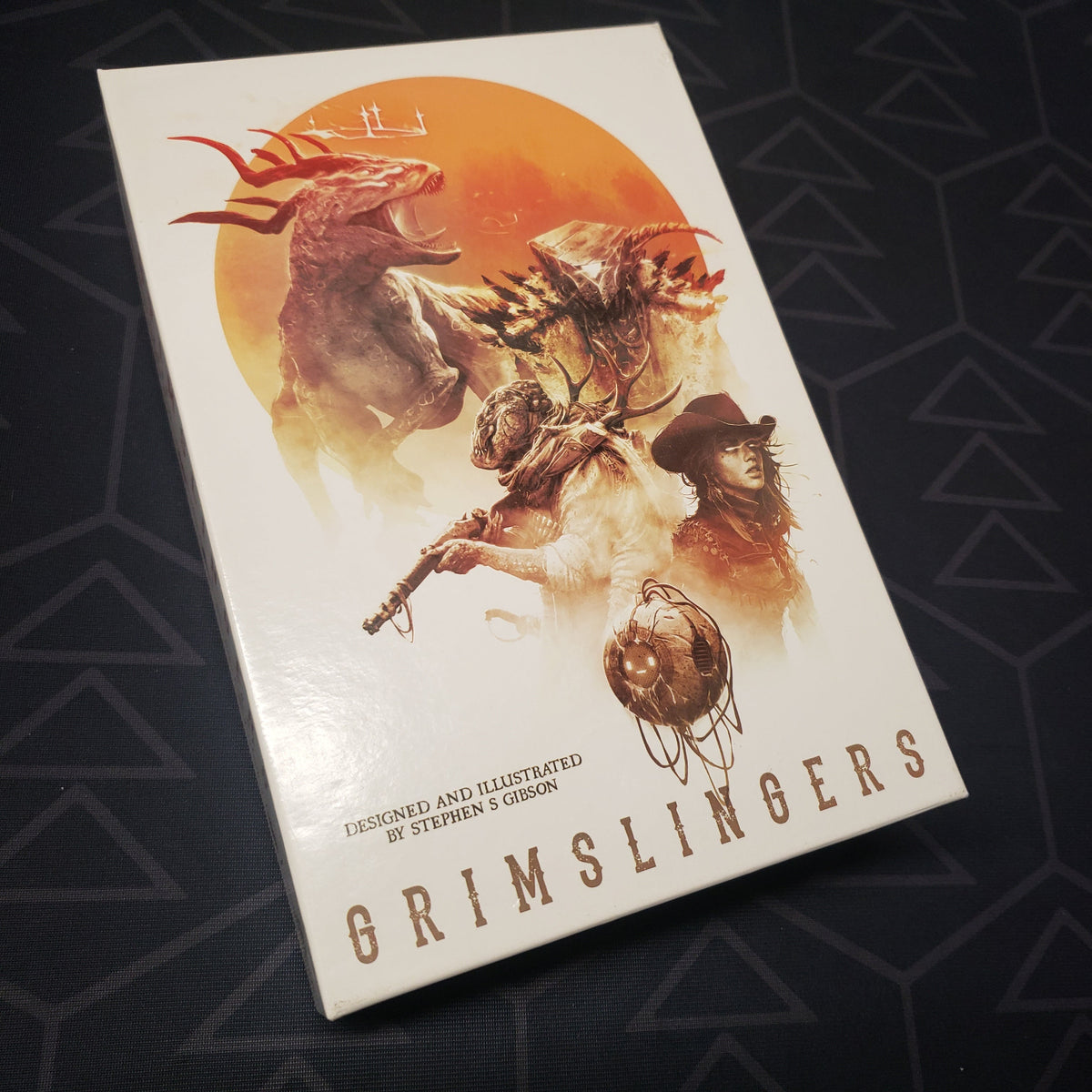 Image shows the front cover of the box for the Grimslingers card game