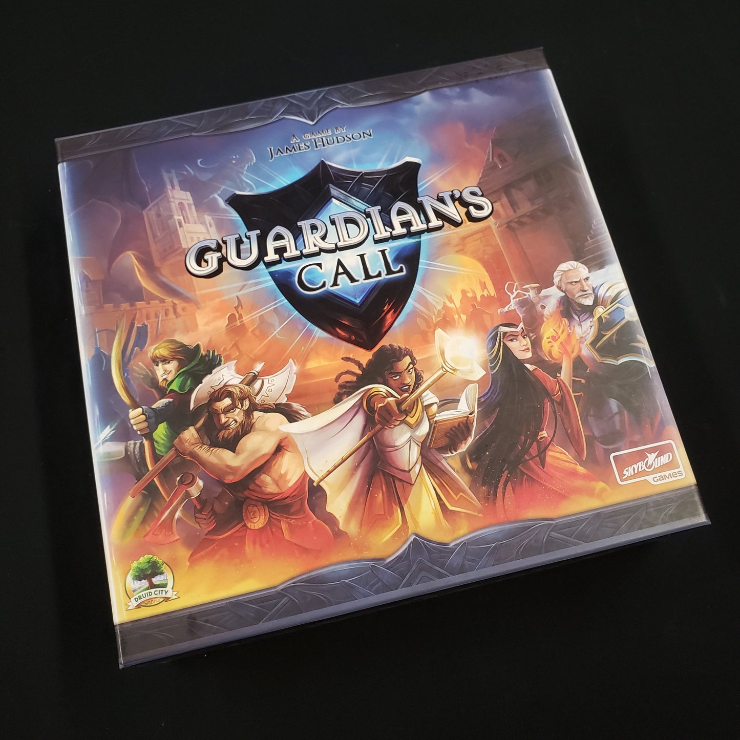 Image shows the front cover of the box of the Guardian's Call board game