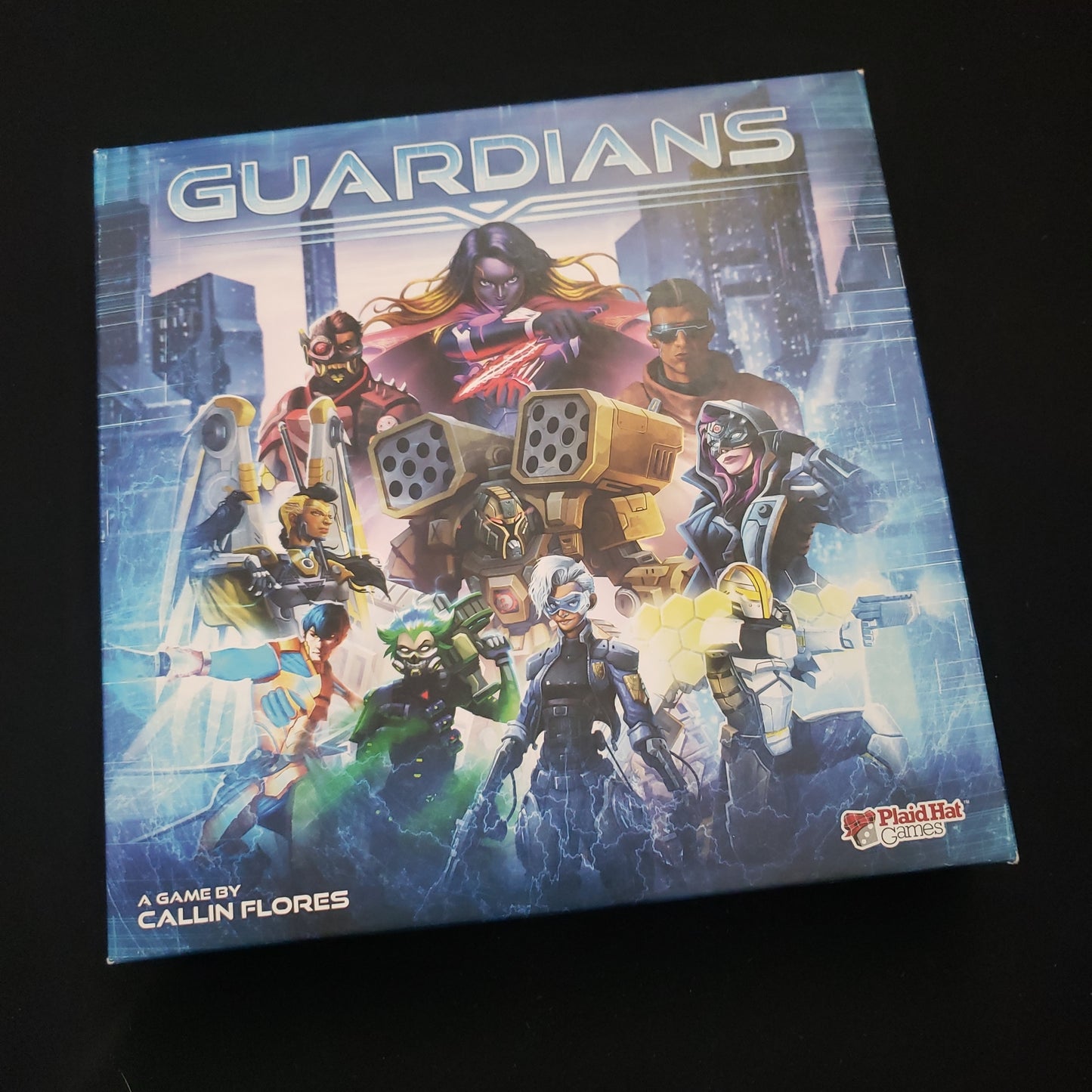 Image shows the front cover of the box of the Guardians card game