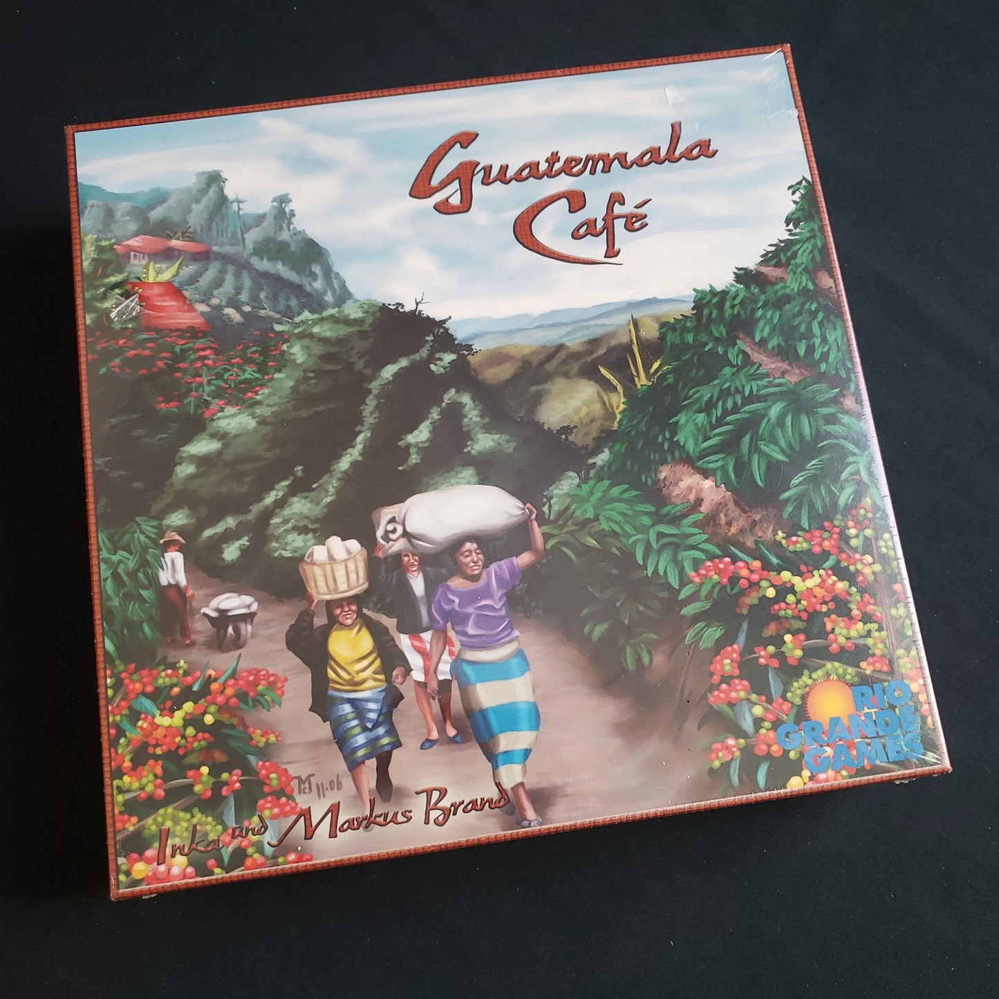 Image shows the front cover of the box of the Guatemala Cafe board game