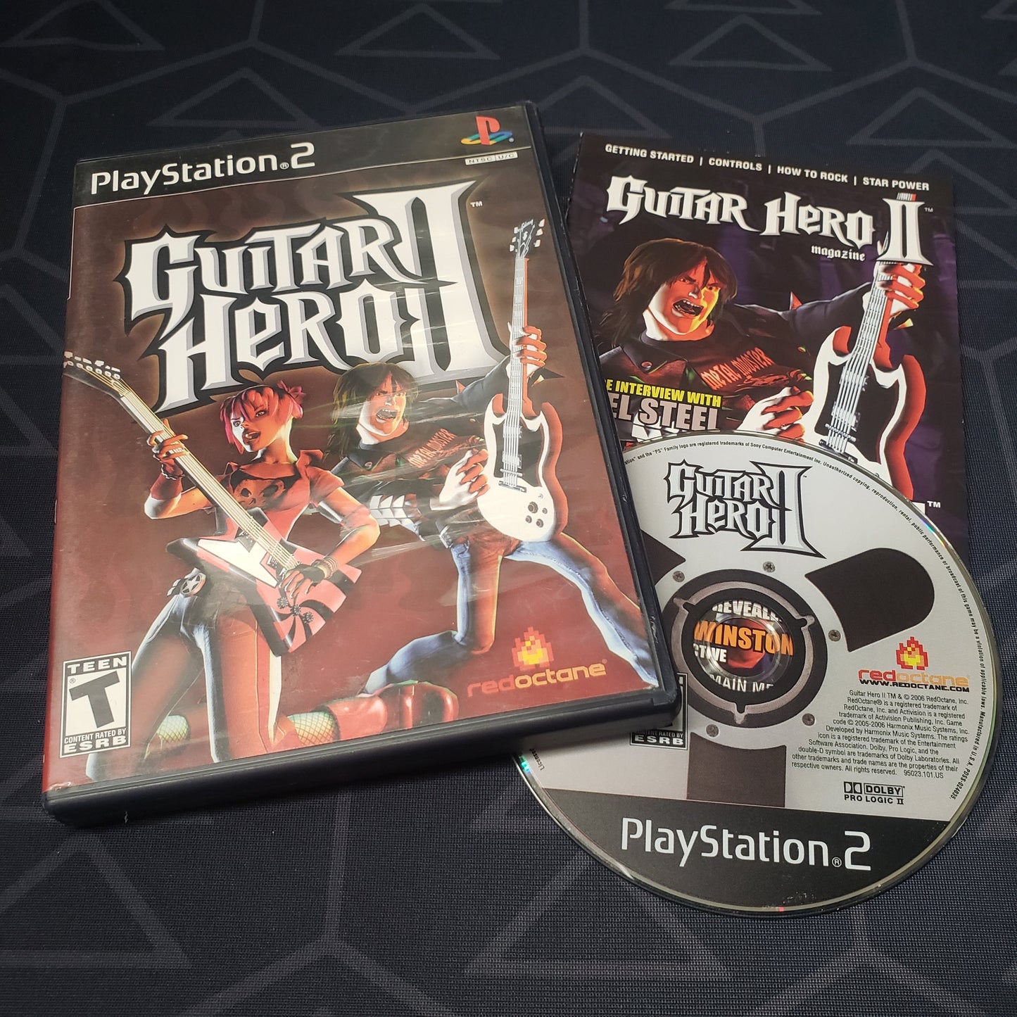 Image shows the case, manual & disc for the video game Guitar Hero II for Playstation 2