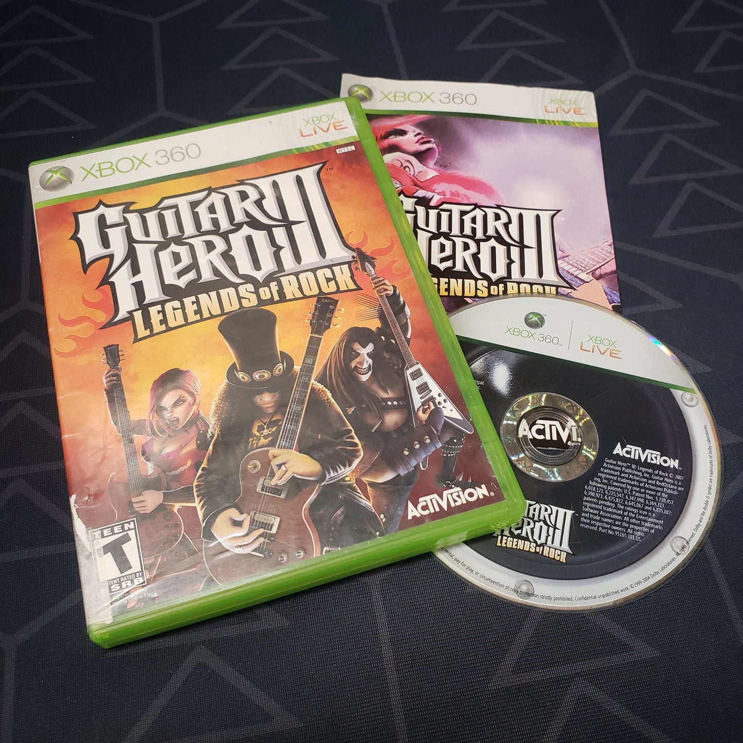 Image shows the case, manual and disc for the video game Guitar Hero III: Legends of Rock for Xbox 360
