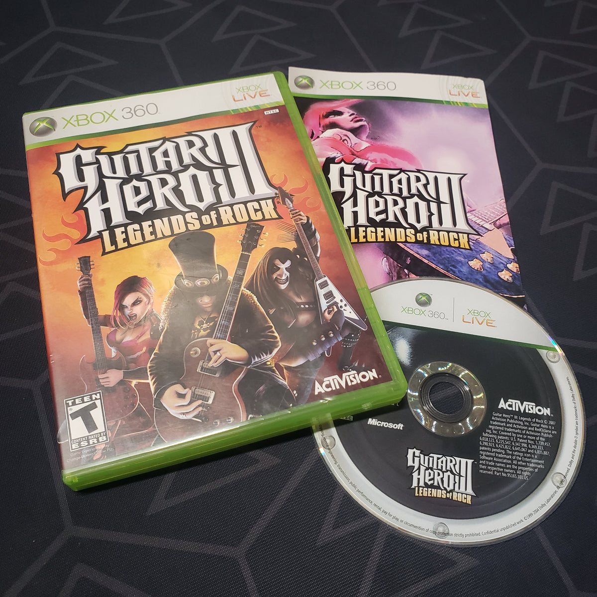 Image shows the case, manual and disc for the video game Guitar Hero III: Legends of Rock for Xbox 360
