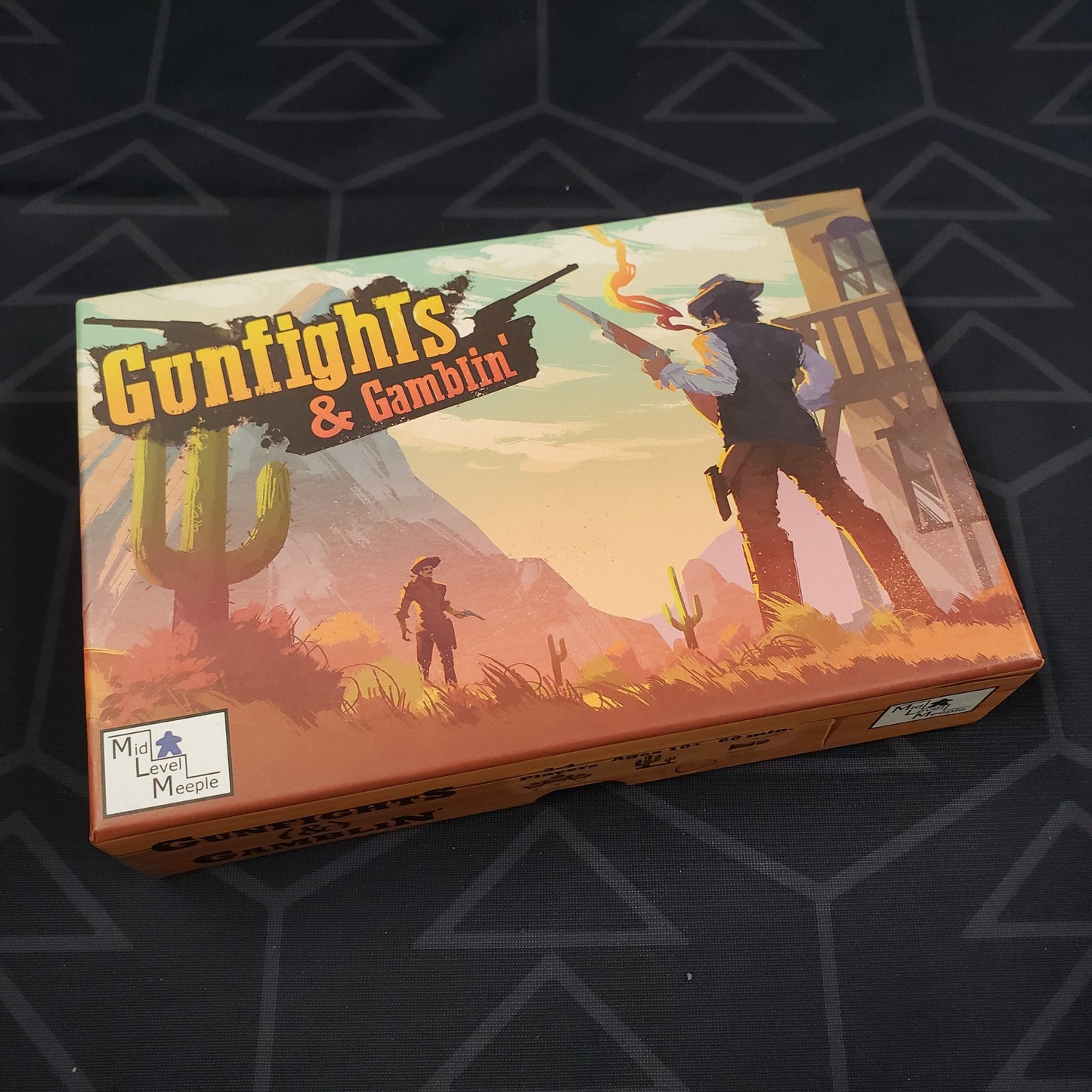 Image shows the front cover of the box of the Gunfights & Gamblin' card game