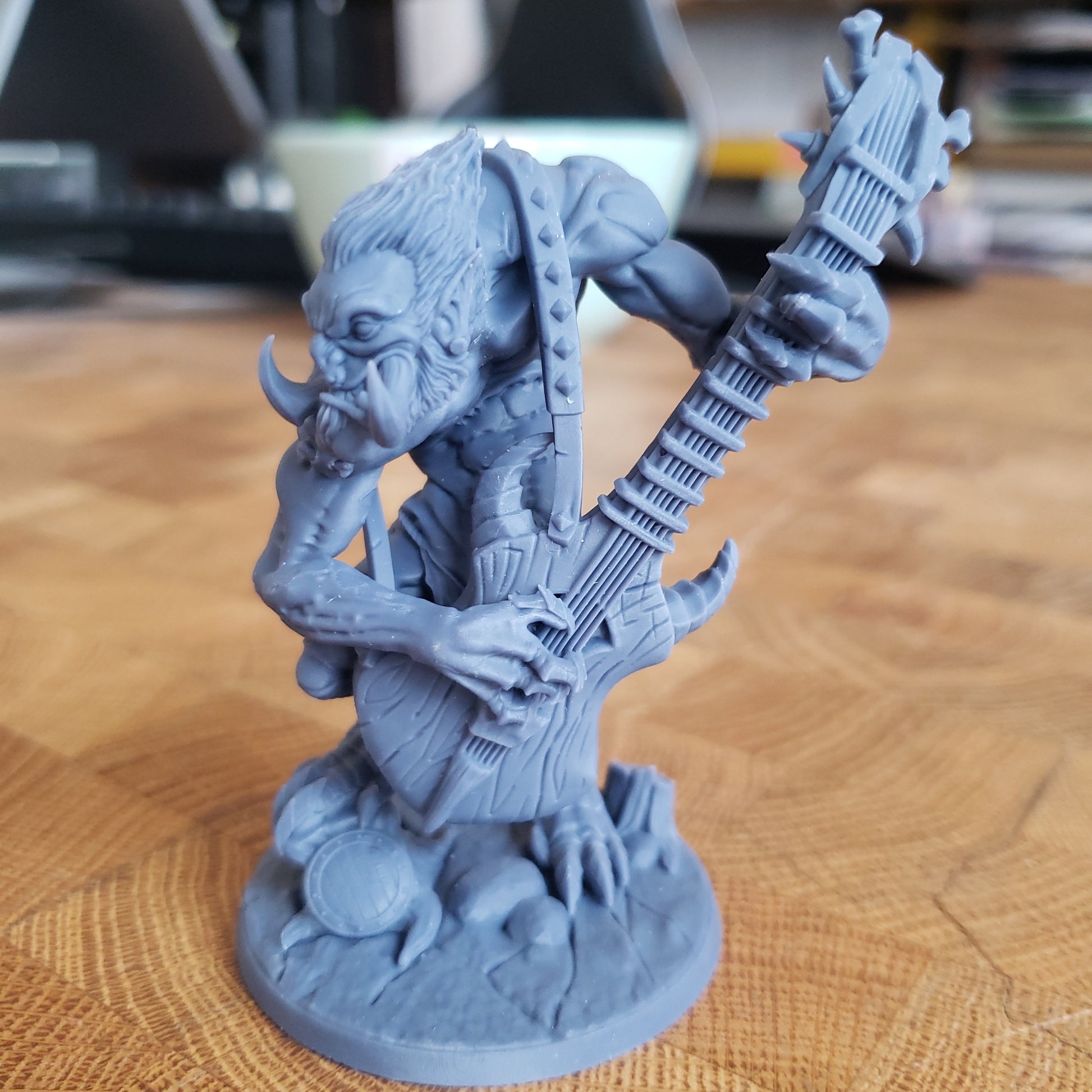 Image shows an example of a 3D printed troll guitarist gaming miniature printed in-house at All Systems Go