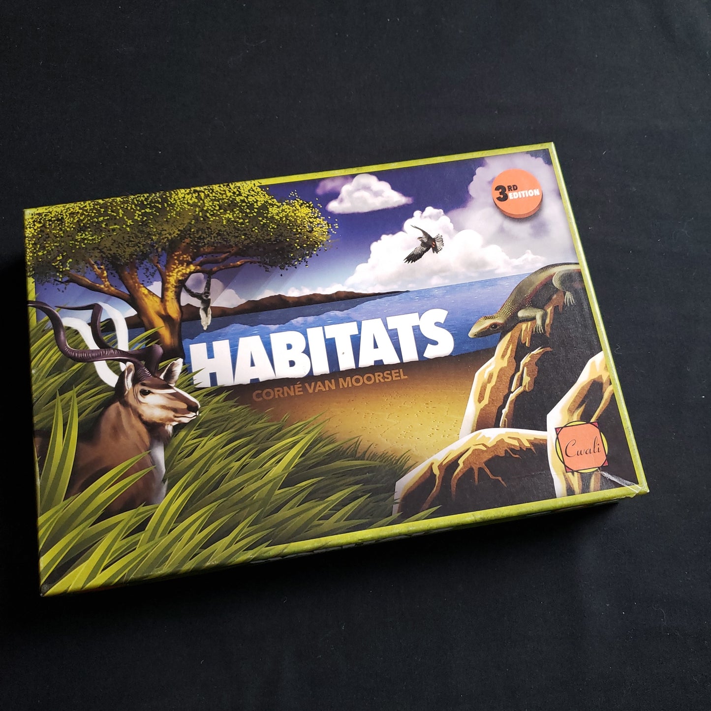 Image shows the front cover of the box of the Habitats board game