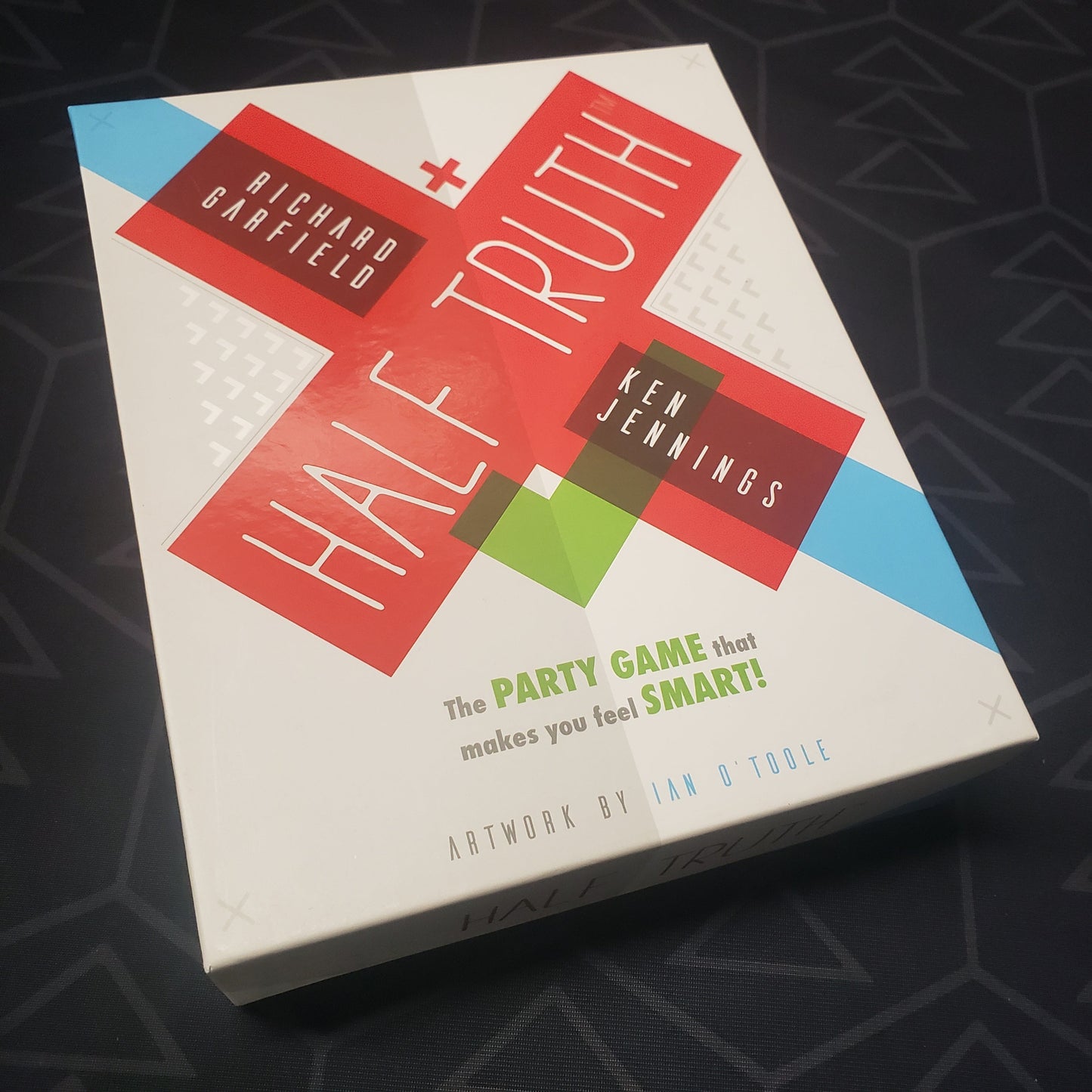 Image shows the front cover of the box for the Half Truth party game