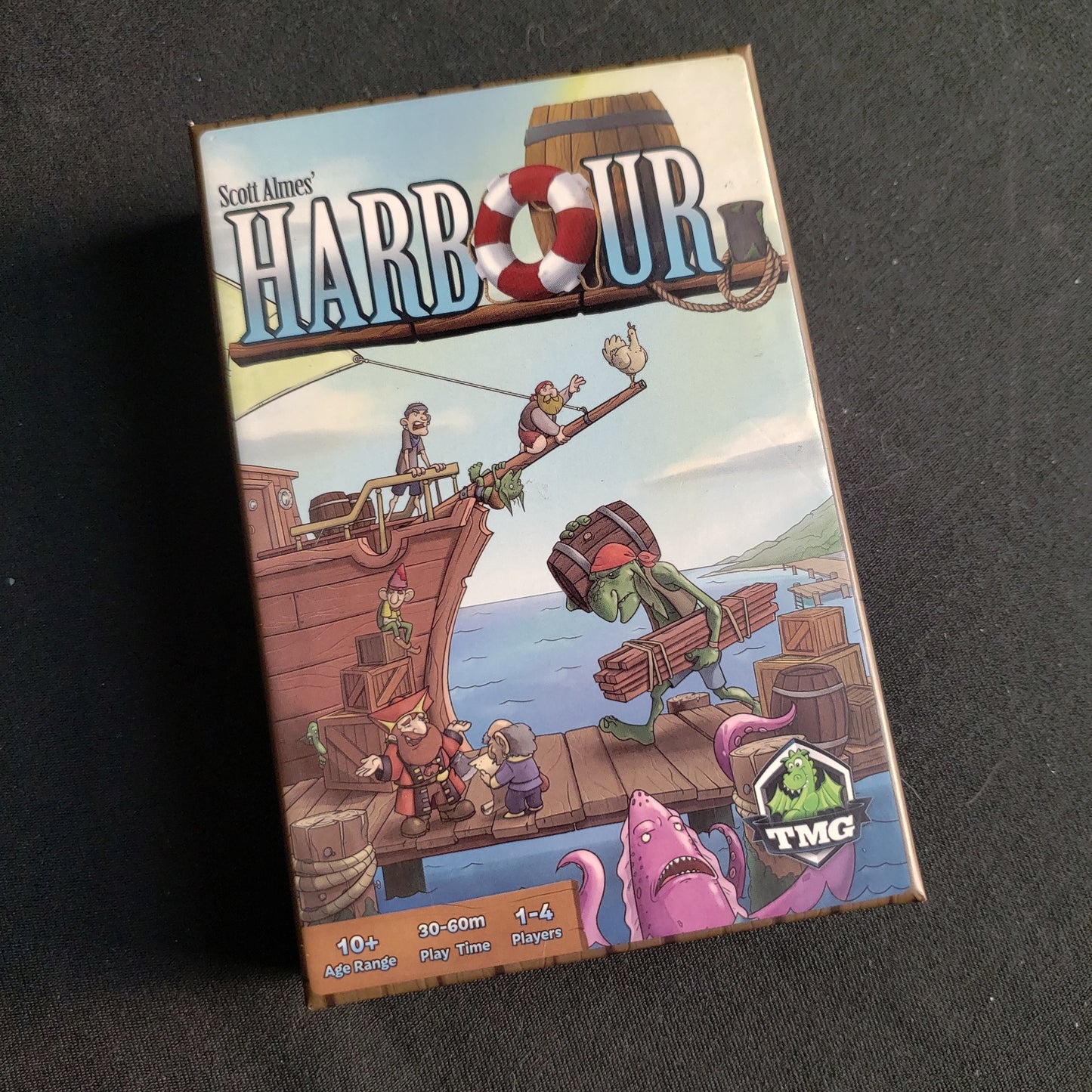Image shows the front cover of the box of the Harbour board game