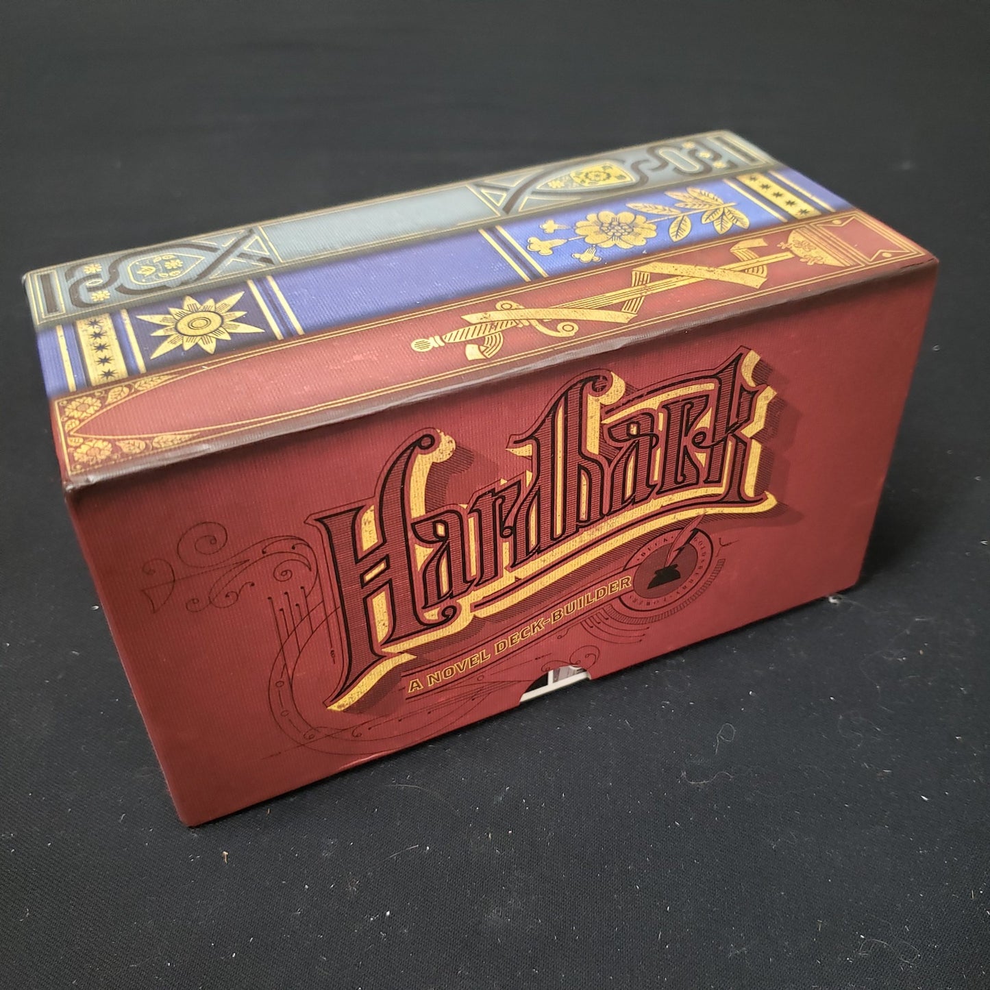 Image shows the front cover of the box of the Hardback card game