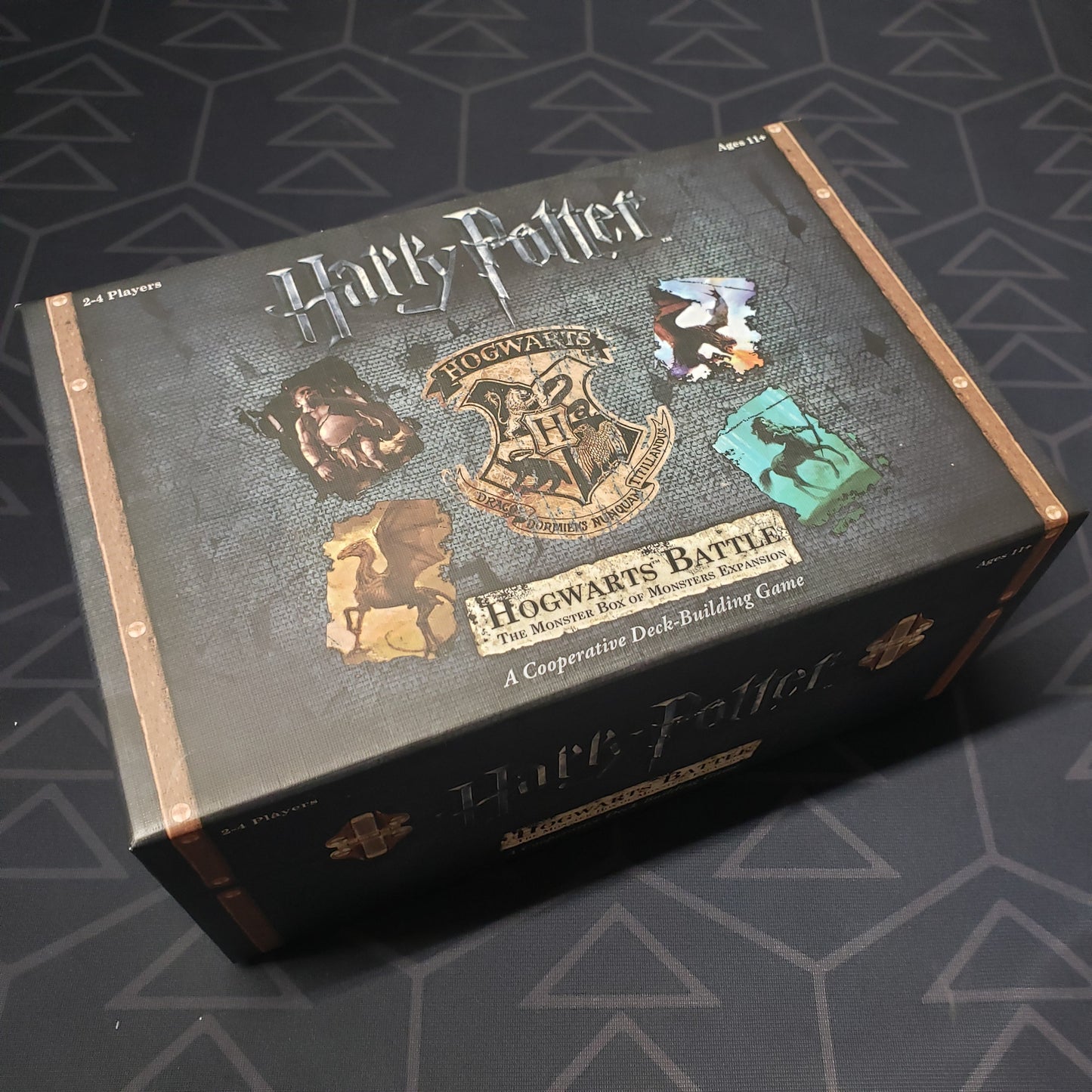 Image shows the front cover of the box of the Monster Box of Monsters expansion for the board game Harry Potter: Hogwarts Battle