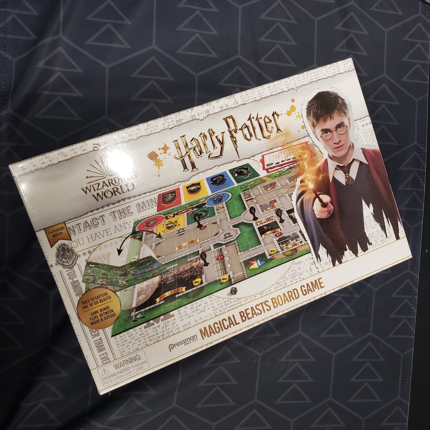 Image shows the front cover of the box for the Harry Potter: Magical Beasts board game