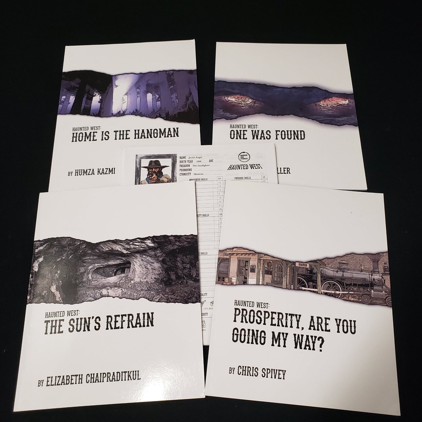 Image shows the front covers of four different adventure module books for the roleplaying game Haunted West