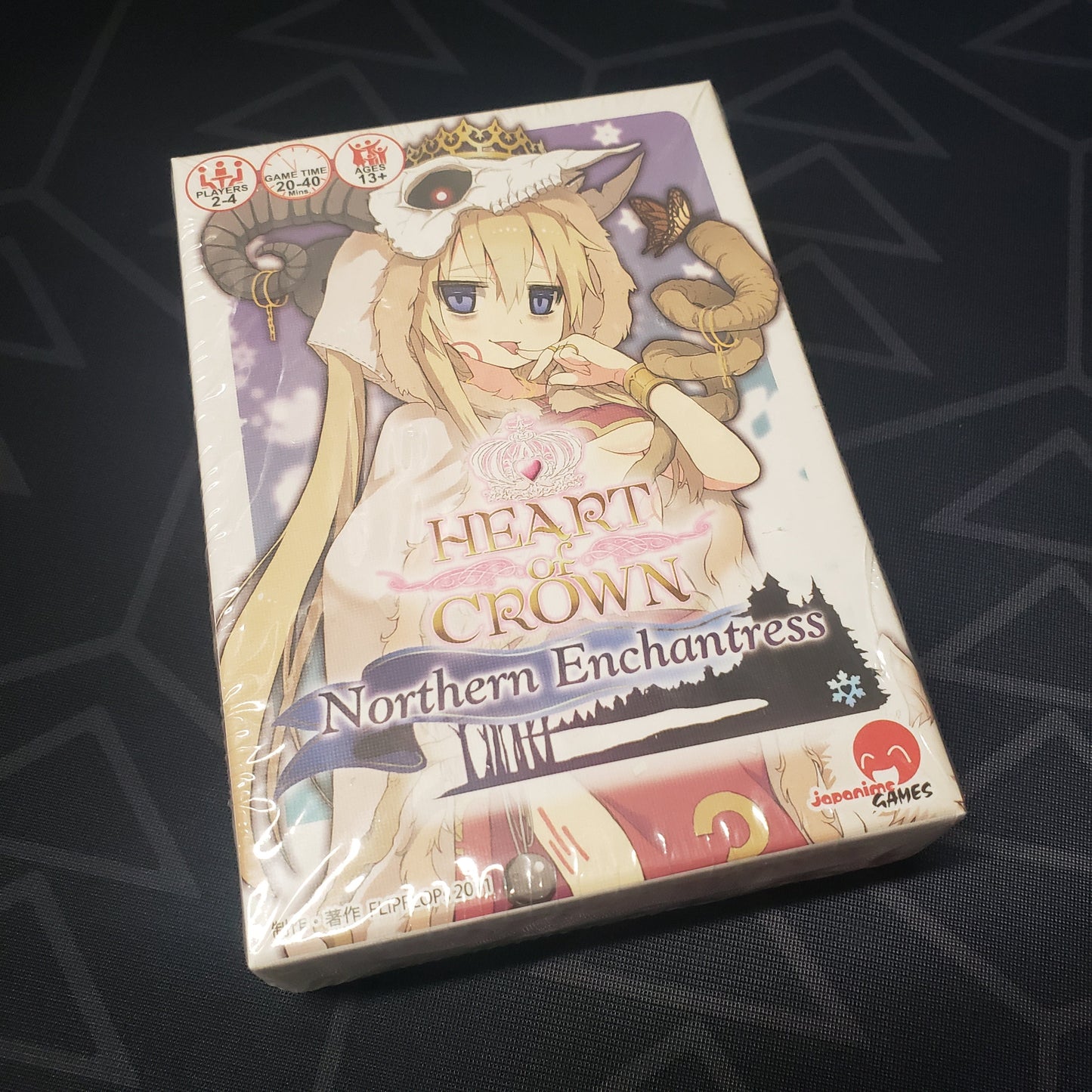 Image shows the front cover of the box of the Northern Enchantress expansion for the card game Heart of Crown